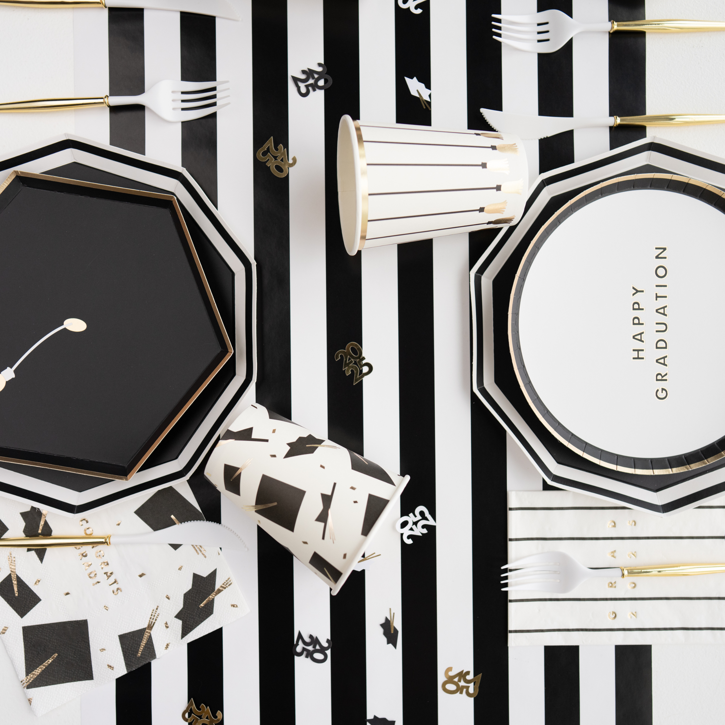 Closeup of white graduation snack plate with gold lettering saying "Happy Graduation"