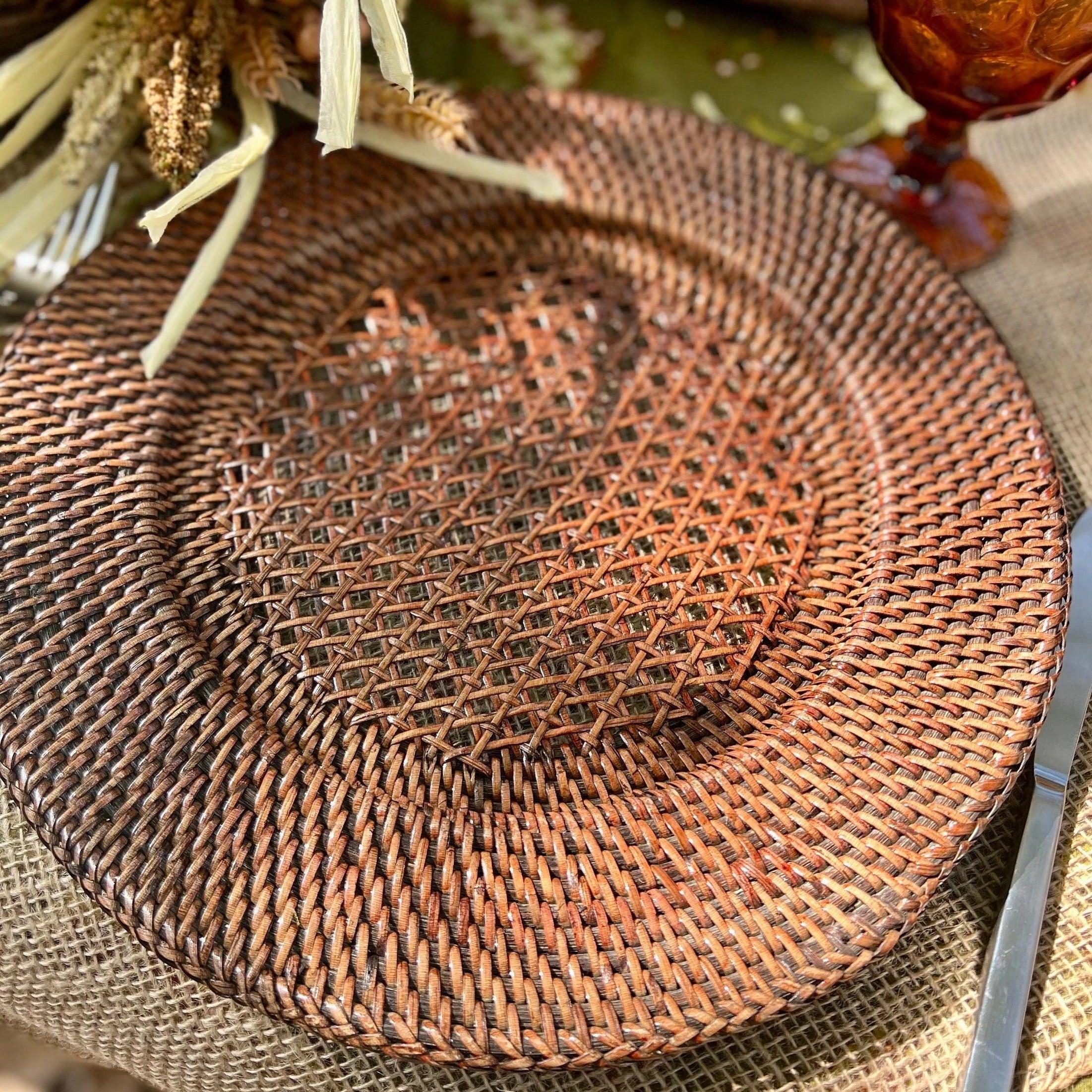 Discover the perfect blend of style and functionality with our Dark Brown Rattan Charger Plates. Crafted from natural wicker, these handmade boho charger plates fit standard dinner plates and add a chic, rustic touch to any meal. Ideal for those seeking brown placemats that combine durability with aesthetic appeal.