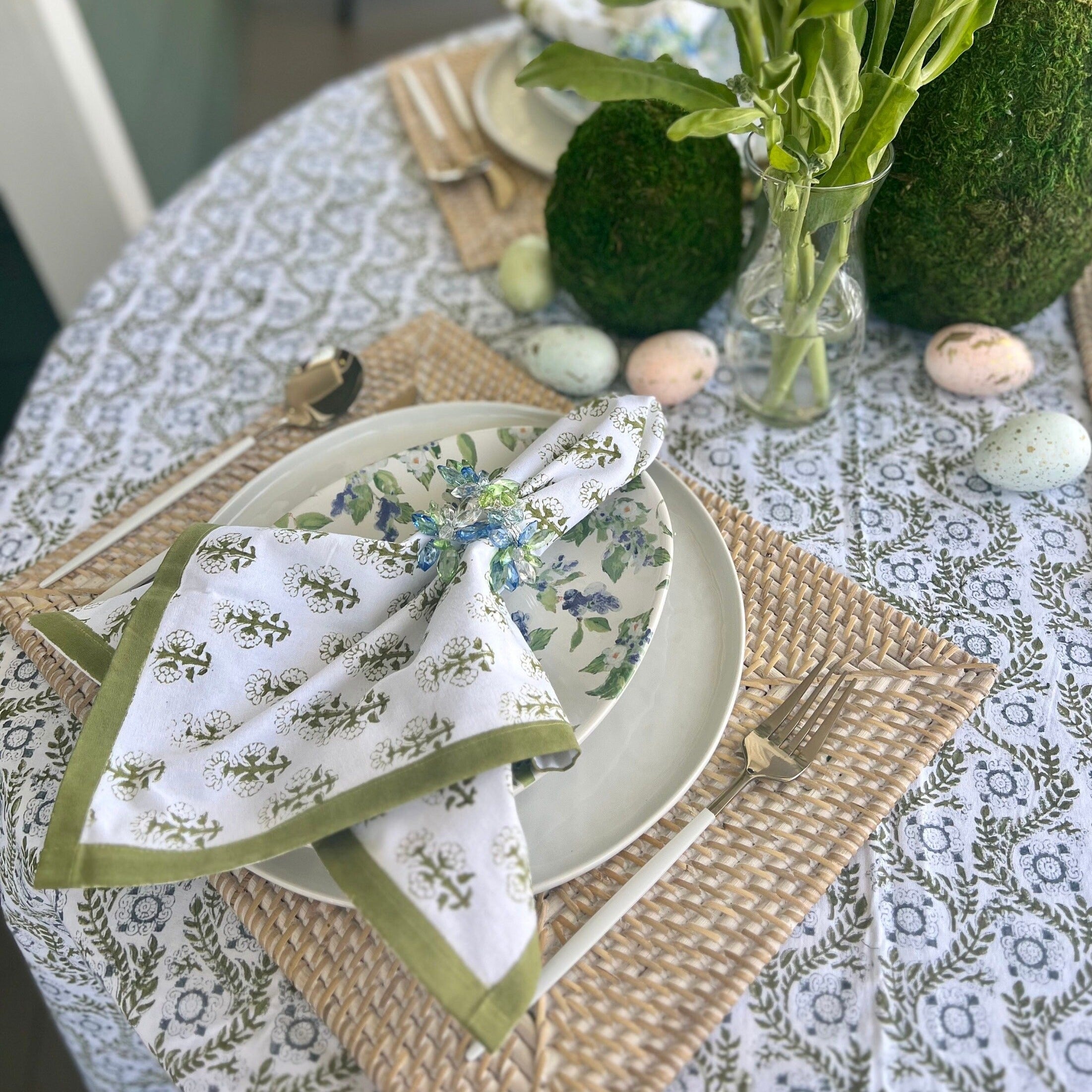Green cloth napkins with a floral design and matching green border - perfect for a Spring table or Easter tablescape.