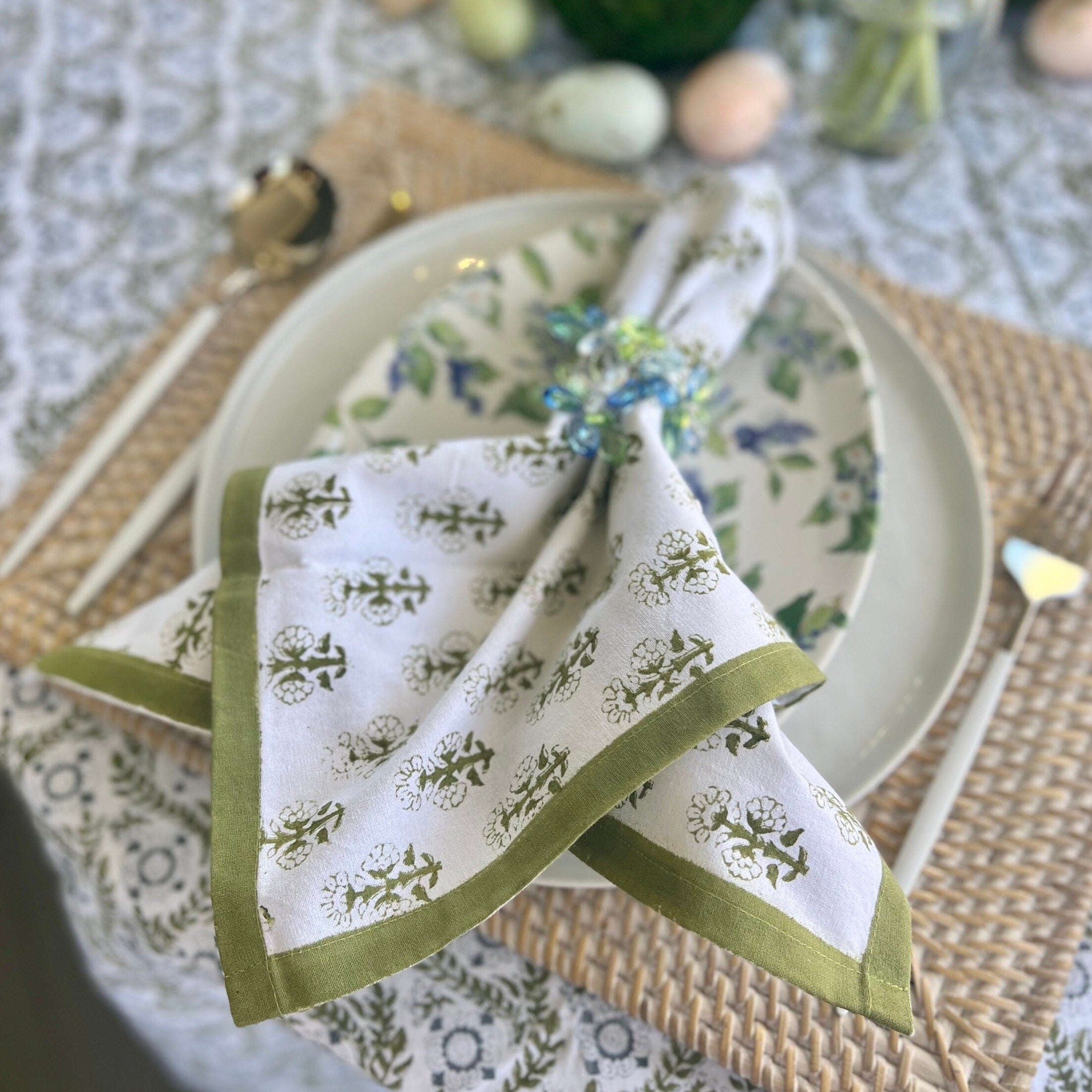 Green cloth napkins with a floral design and matching green border - perfect for a Spring table or Easter tablescape.