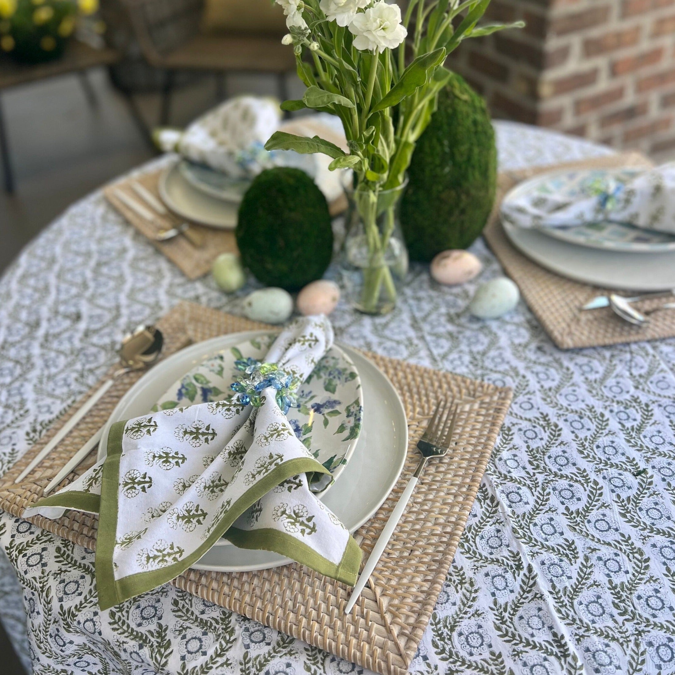 Green cloth napkins with a floral design and matching green border - perfect for a Spring table or Easter tablescape.