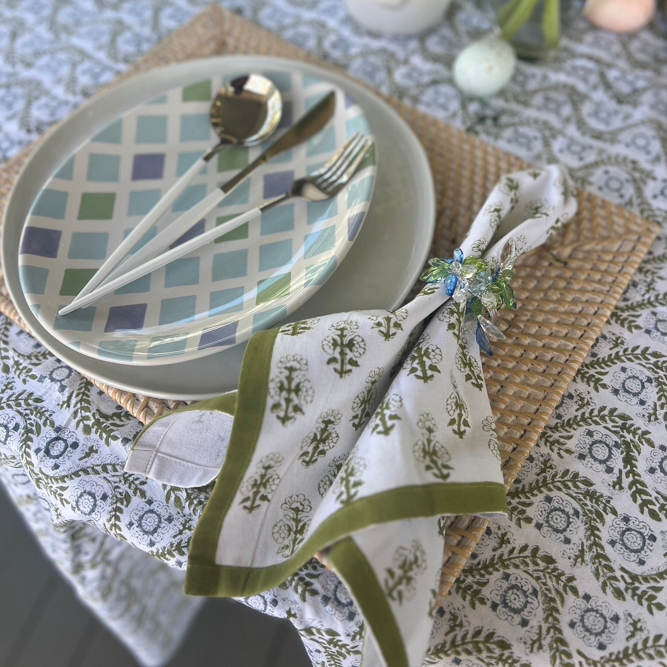 Green cloth napkins with a floral design and matching green border - perfect for a Spring table or Easter tablescape.