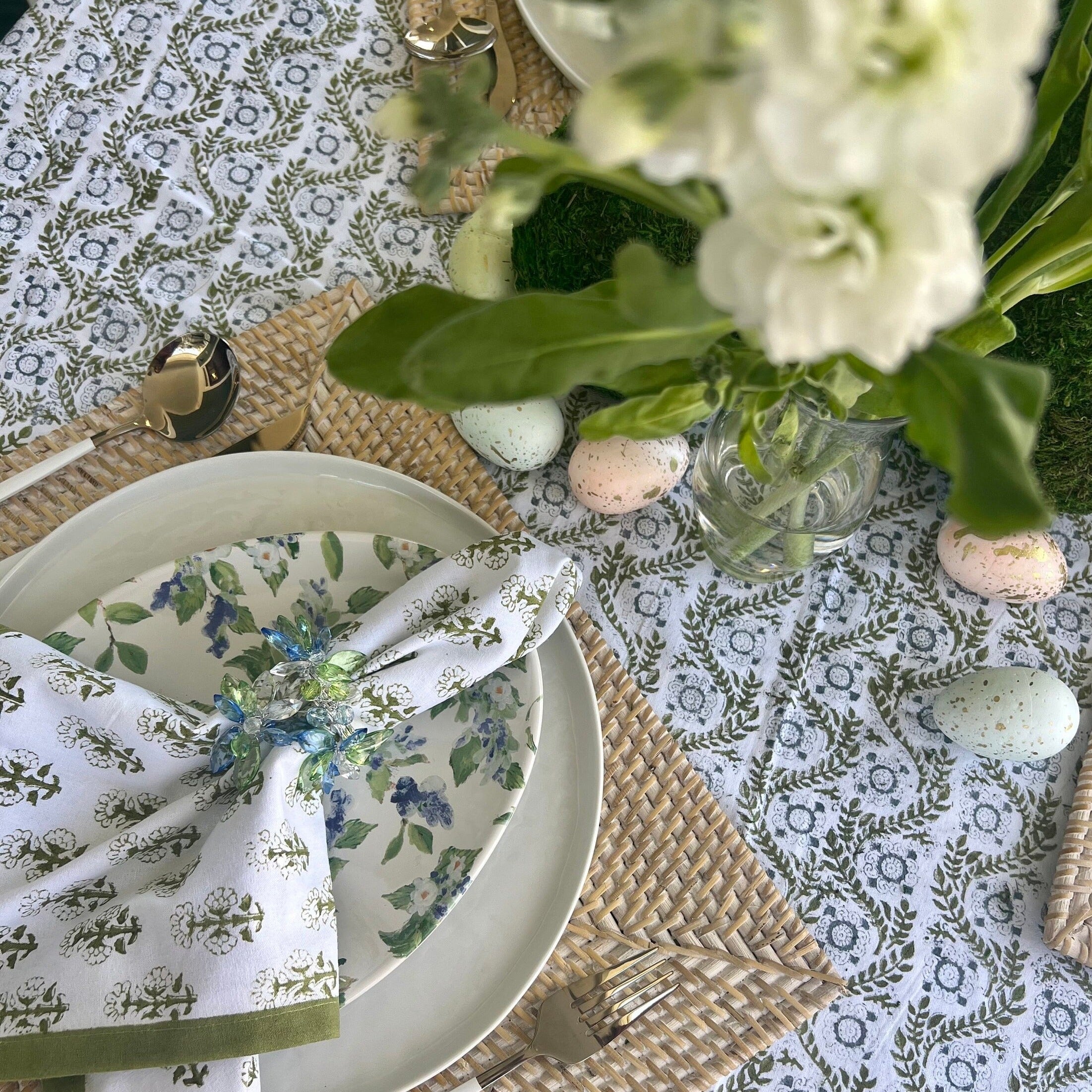 Green cloth napkins with a floral design and matching green border - perfect for a Spring table or Easter tablescape.