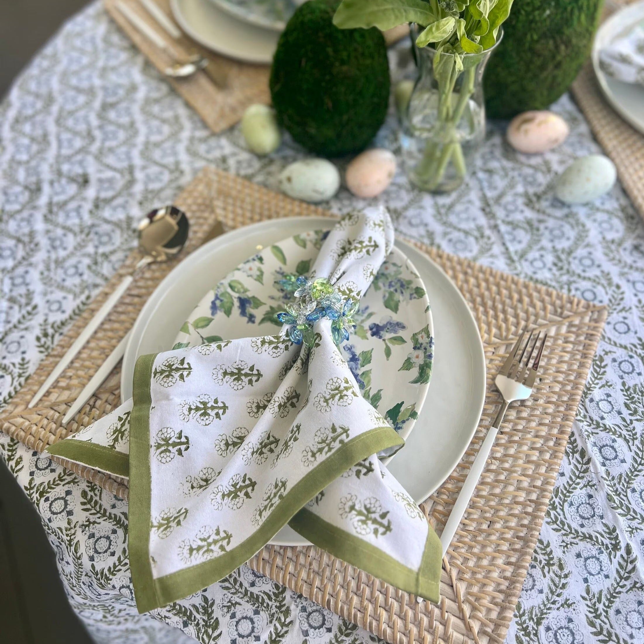 Green cloth napkins with a floral design and matching green border - perfect for a Spring table or Easter tablescape.