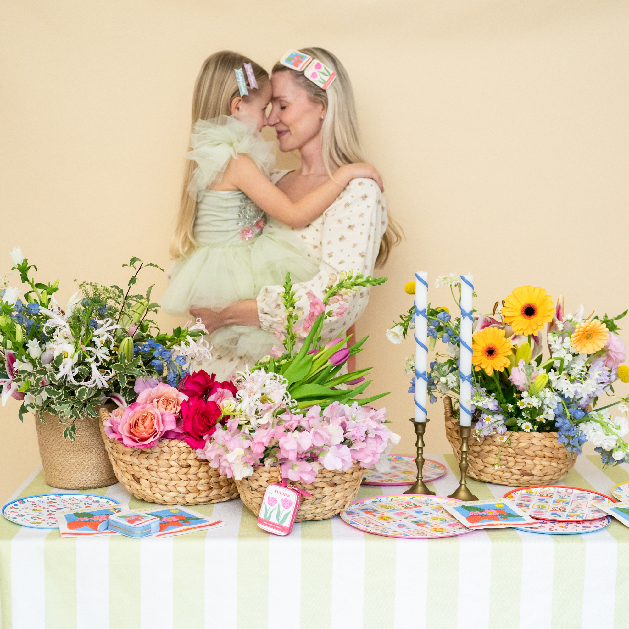 Mother and child near Easter garden party tablescape with In Bloom collection and strawberry seed napkins