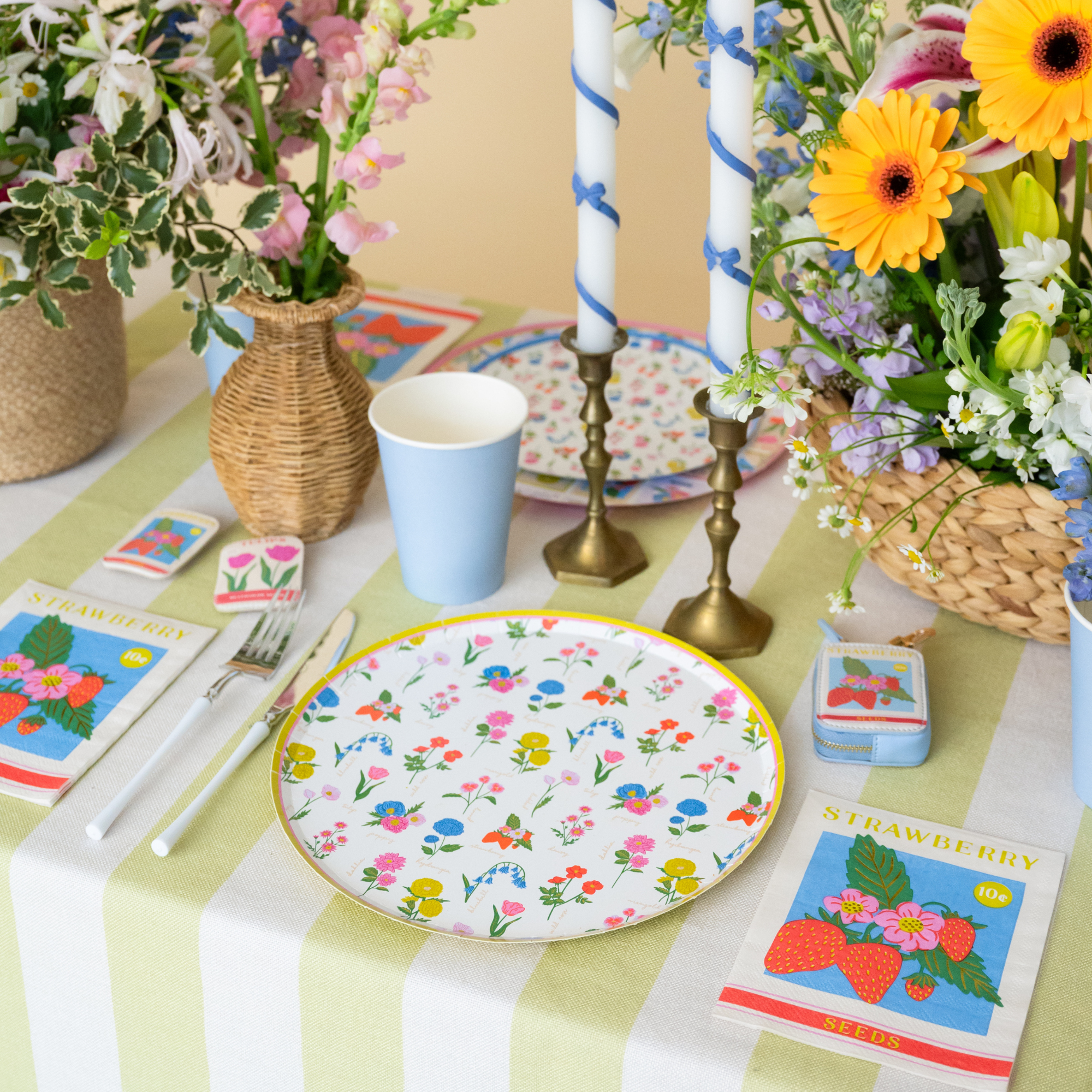 In Bloom floral dinner plate styled on a spring table with flowers and candles