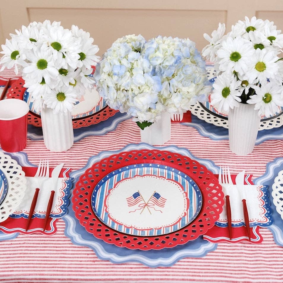 Multiple 8.5-inch Party Plates arranged on a striped tablecloth for a Preppy Patriotic Table Setting.