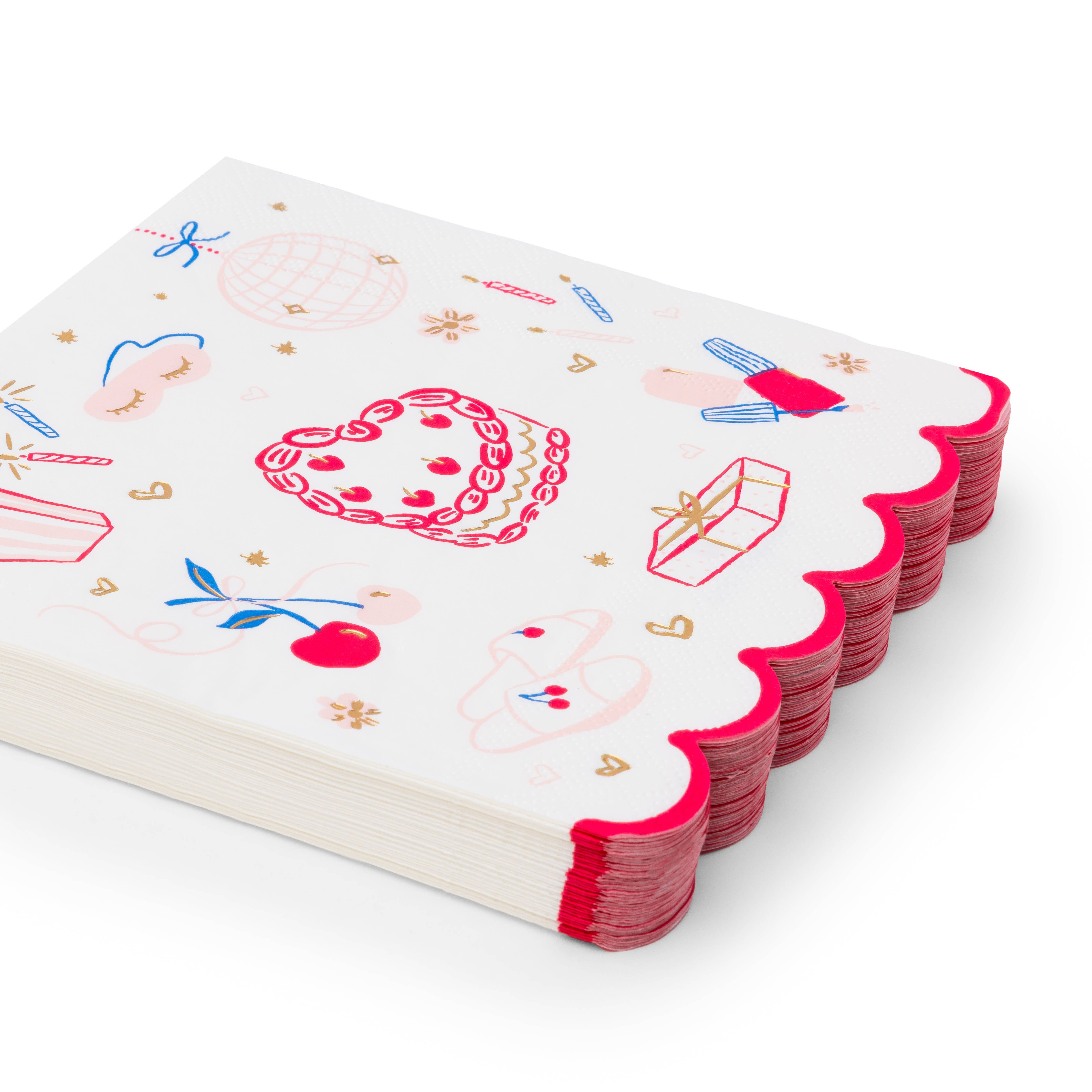 Angled stack of white large party napkins with illustrated birthday icons and hot pink scalloped edge on white background