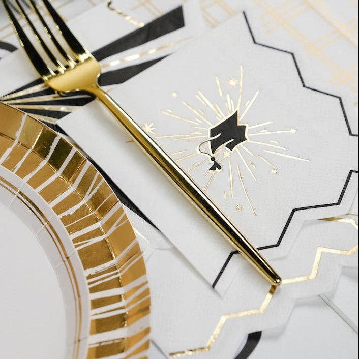 Close-up of a Heritage Graduation napkin paired with a gold foil plate for a refined Alumni Social.