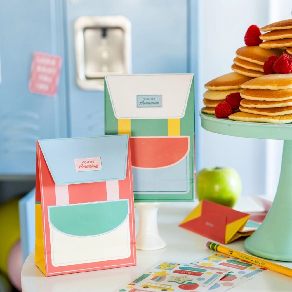 Lunchbox notes displayed with school-themed setup and pancakes.