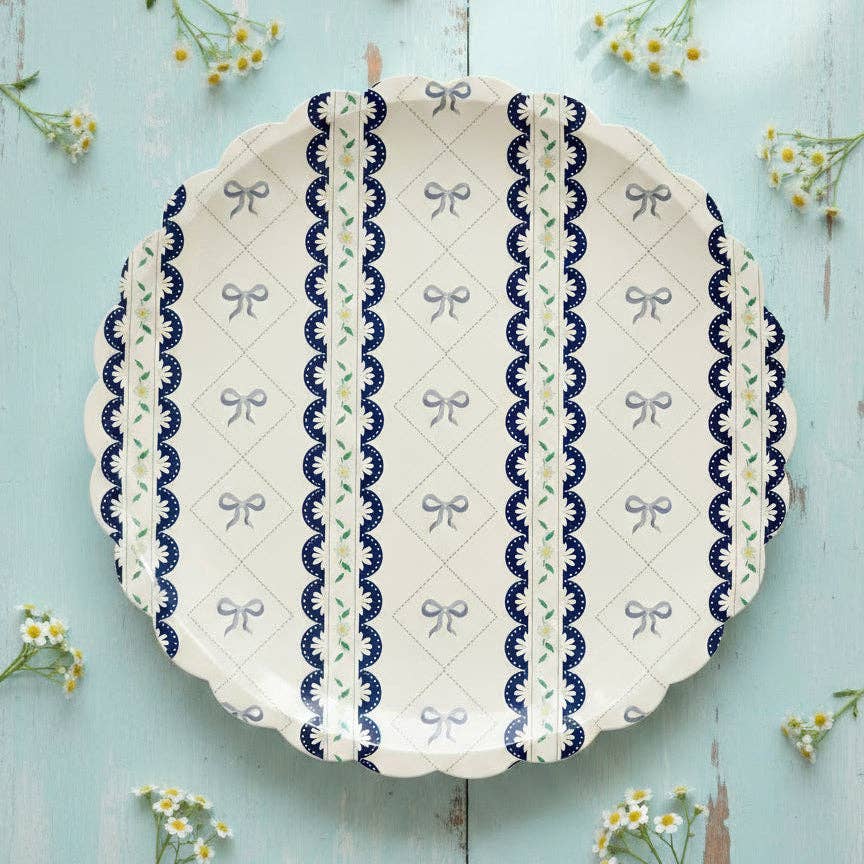 Blue ribbon dinner plate centered on a light blue wood surface with yellow flowers