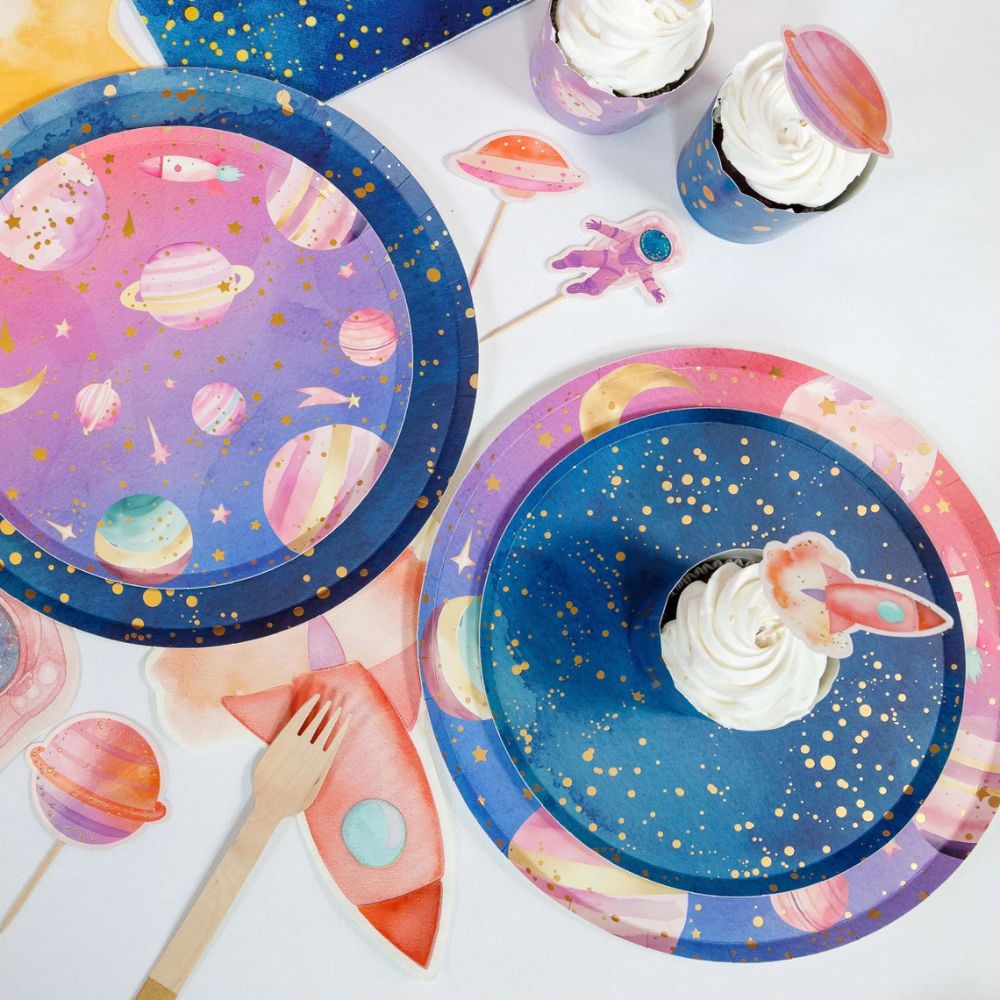 layered galaxy plates with cupcake and space party setup