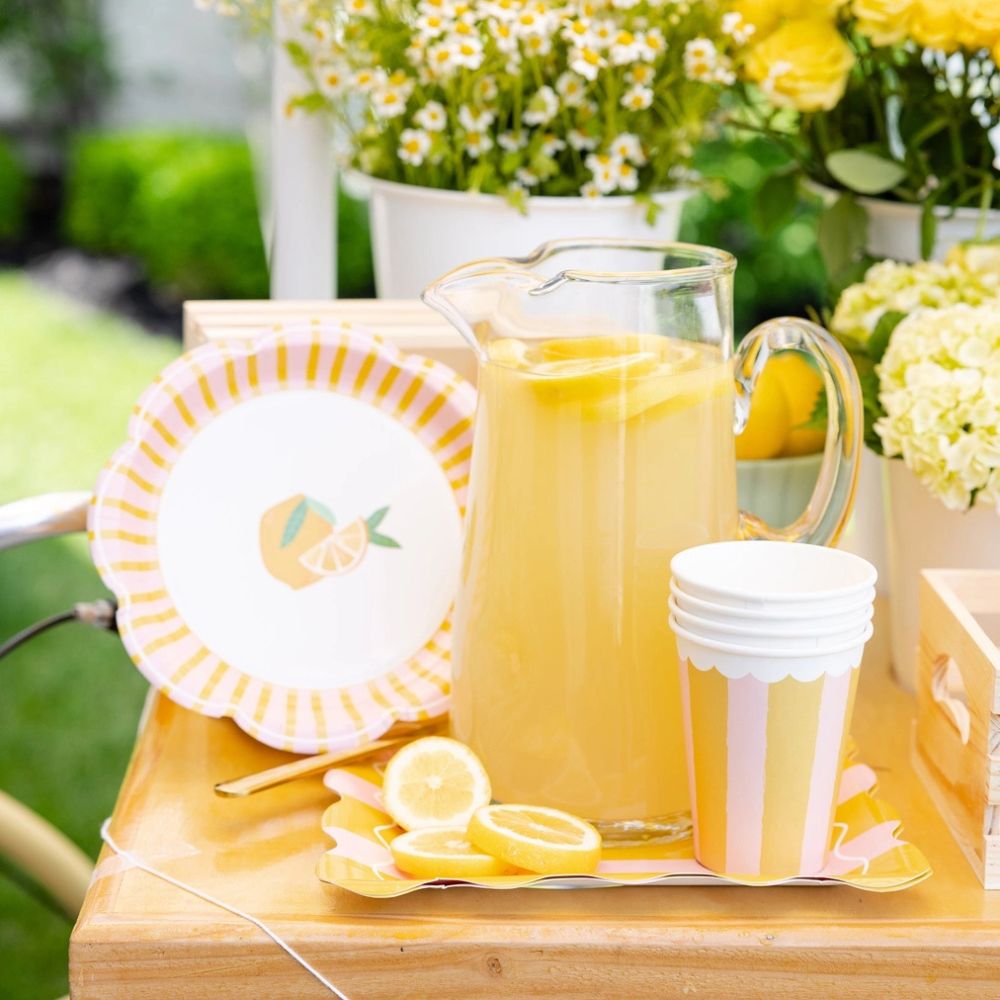 Lemon party setup with striped cups and matching plates