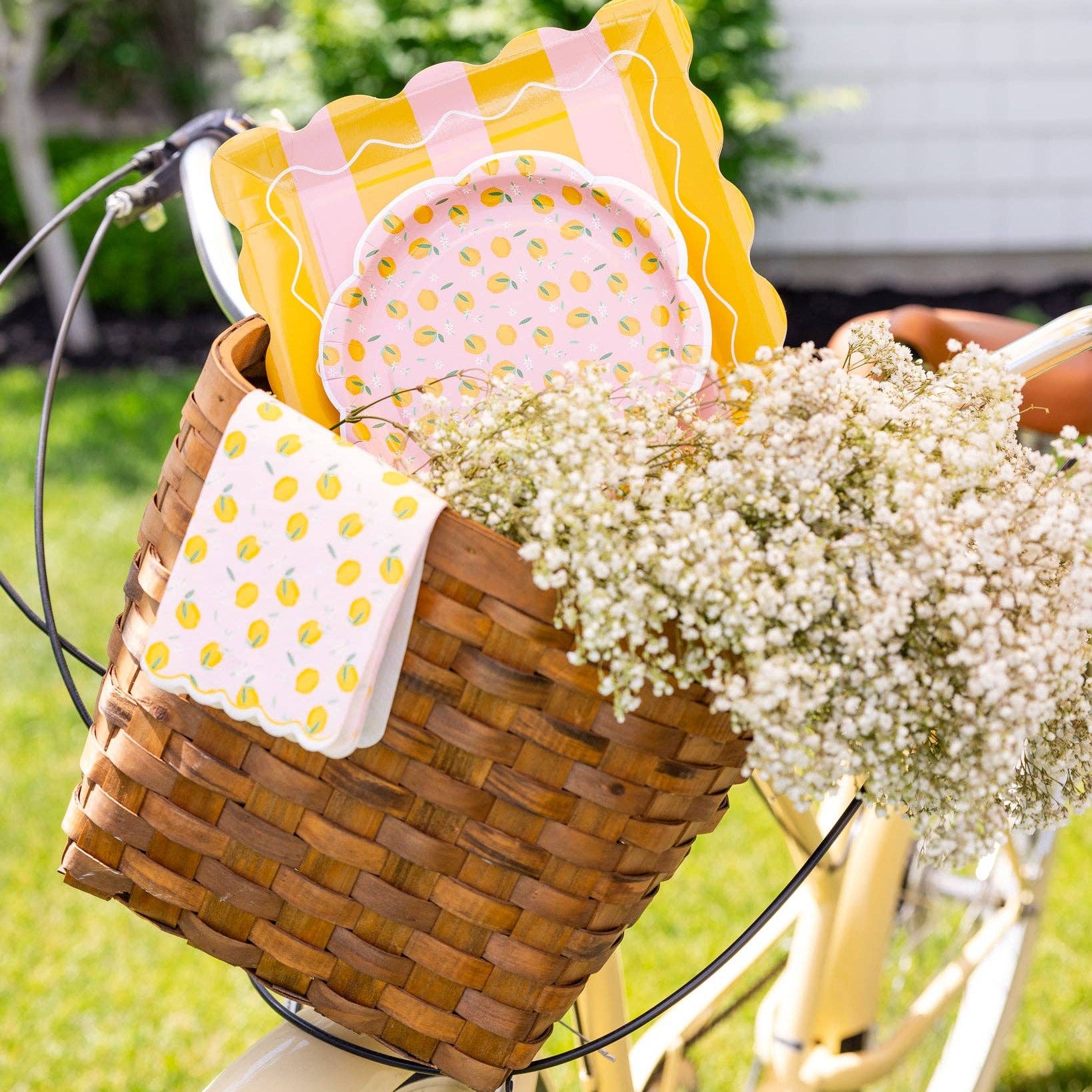 Lemon party setup with plates in basket on bicycle