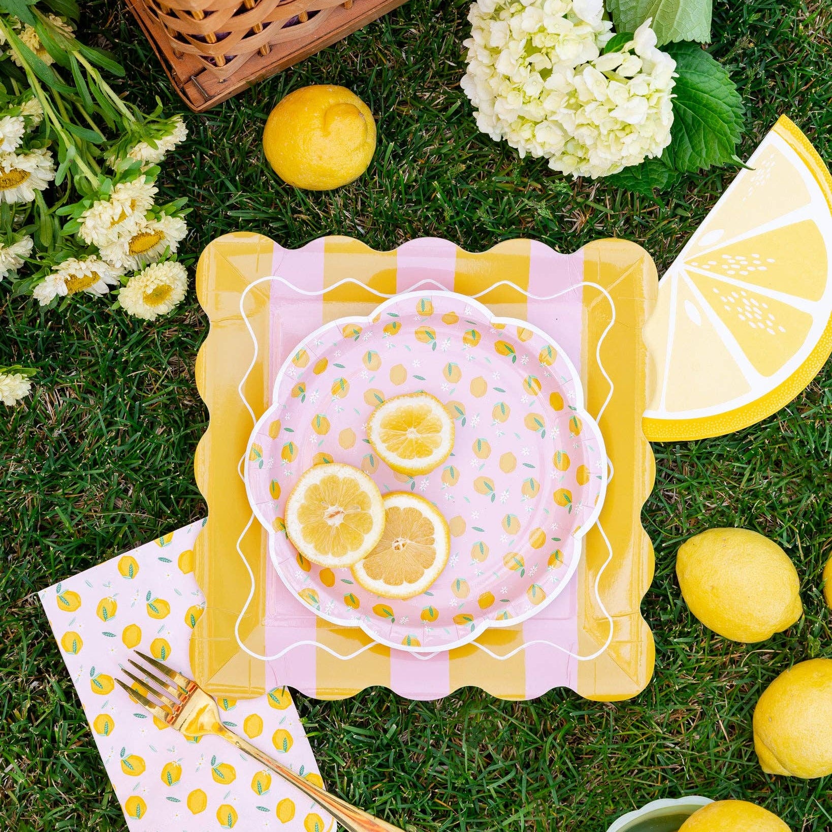 Lemon themed party setup with layered plates and citrus decor