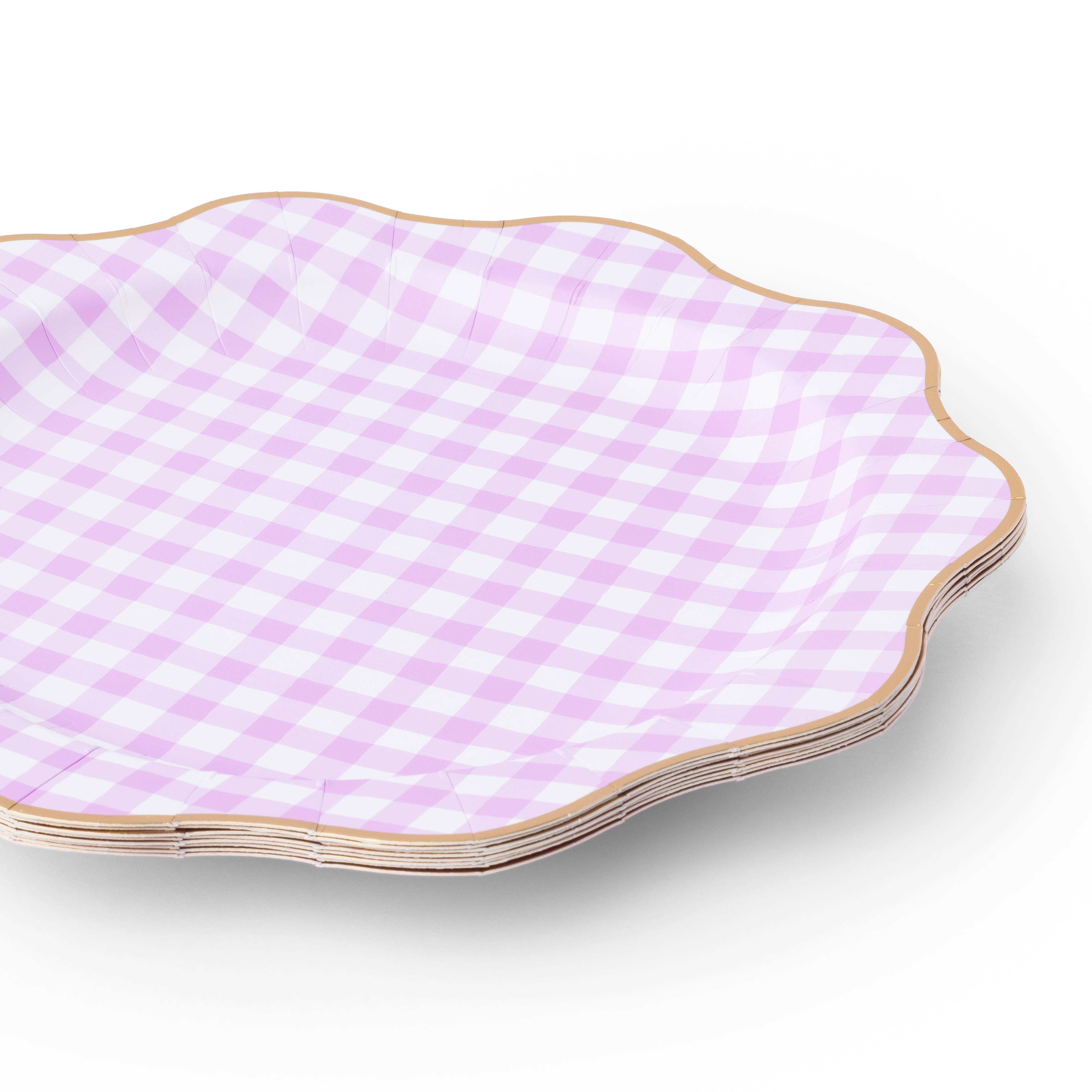 Stack of lilac gingham dinner plates with gold trim detail