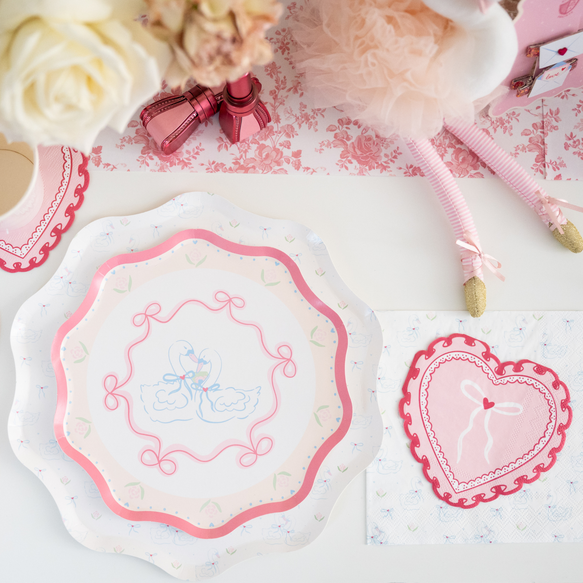 Love Birds small paper plates styled on a romantic pink party table