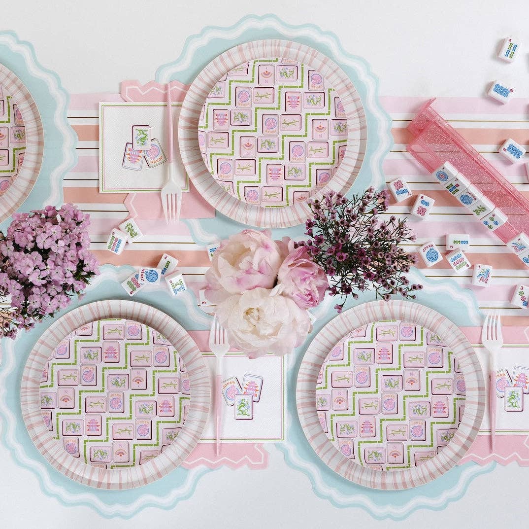 Overhead view of a Mahjong Party Supplies setup featuring plates, tiles, and a striped runner.