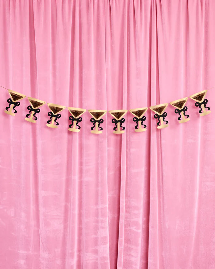 Full 5-foot martini glass banner pre-strung across pink velvet curtain with ten accordion pieces