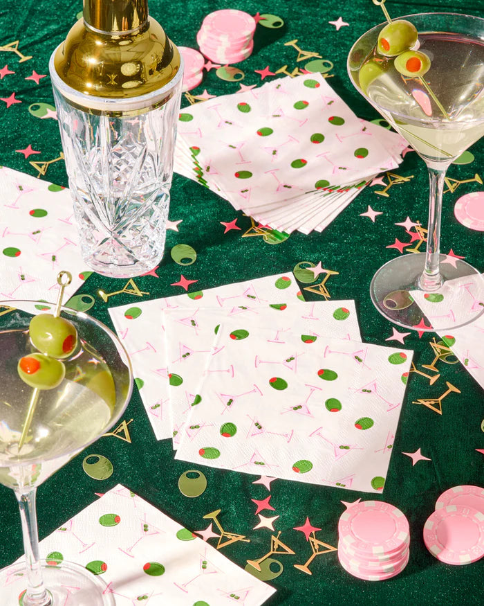 Dirty martini print cocktail napkins styled with martini glasses and crystal shaker on green velvet