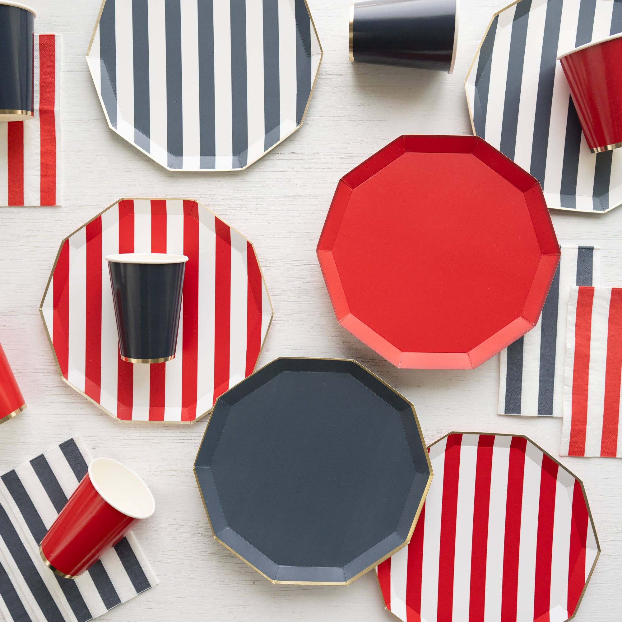 Patriotic red, white & blue styling: Navy dinner plates styled with red and striped plates and matching party cups.