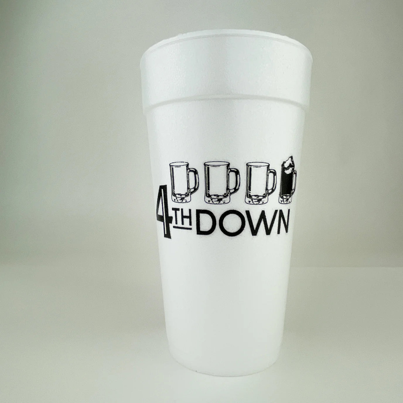 Close front view of white foam cup showing 4th DOWN text and mug icons.