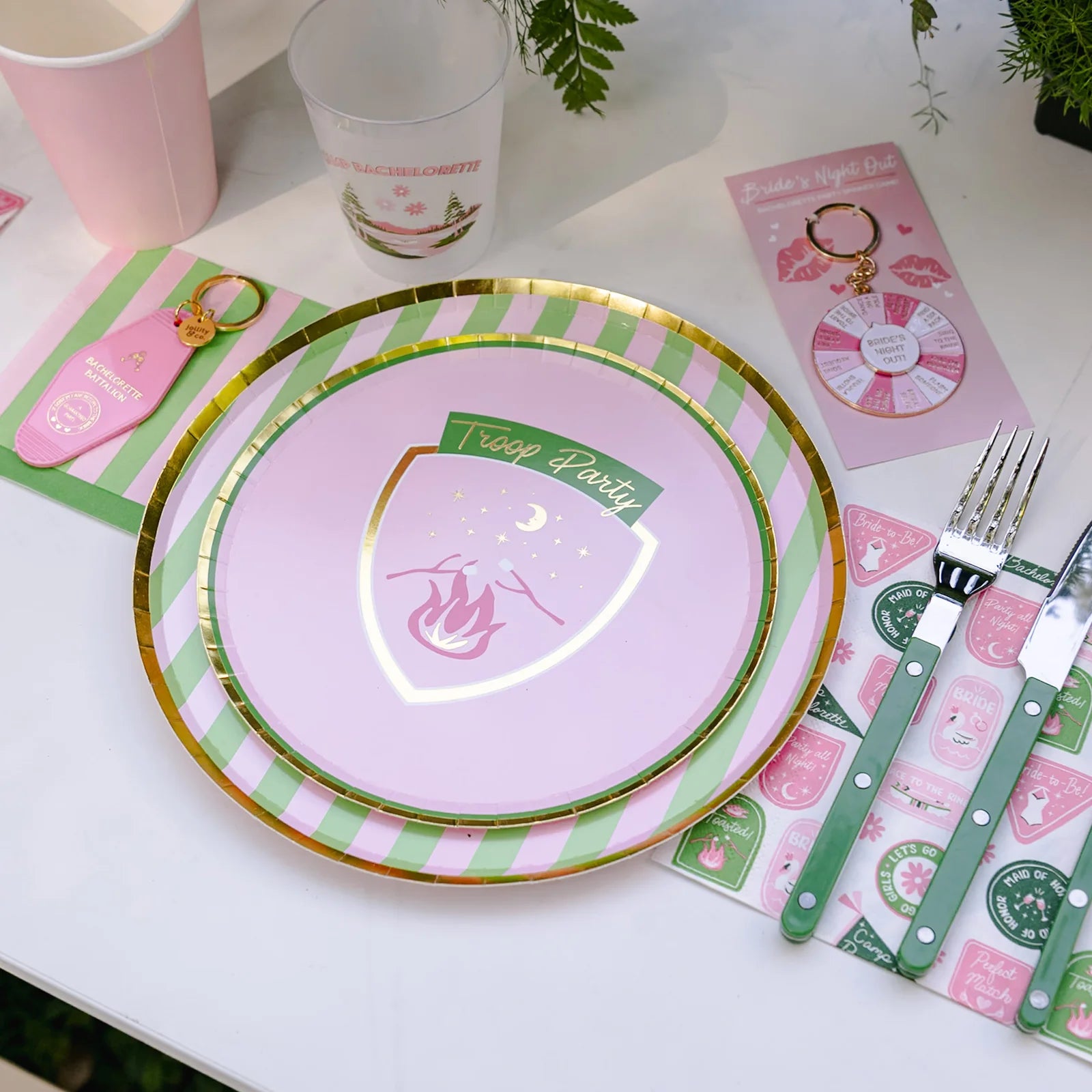 Camp Bachelorette tablescape with pink and green striped napkin under key tag and plates