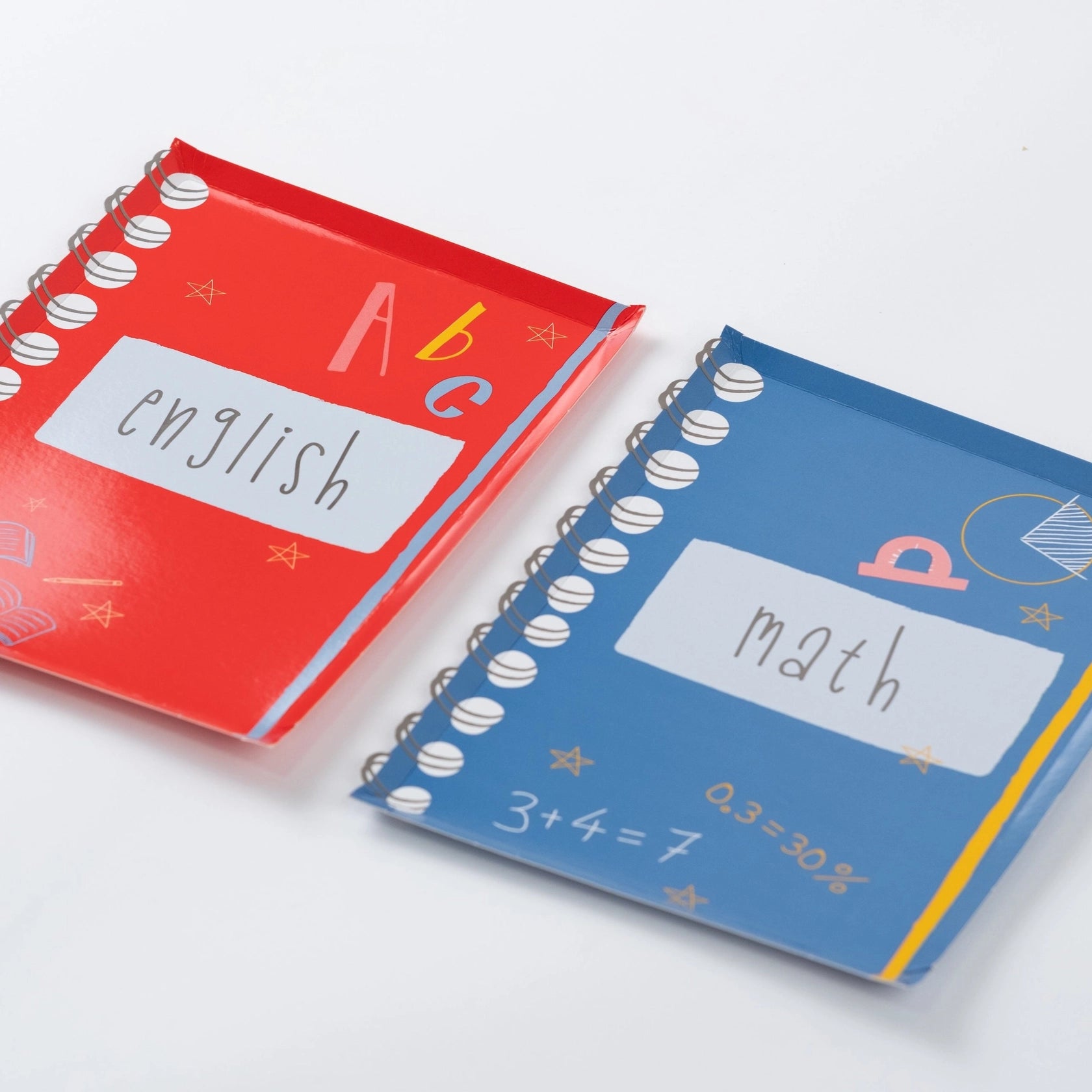 Stack of red notebook plates showing glossy finish and spiral edge.