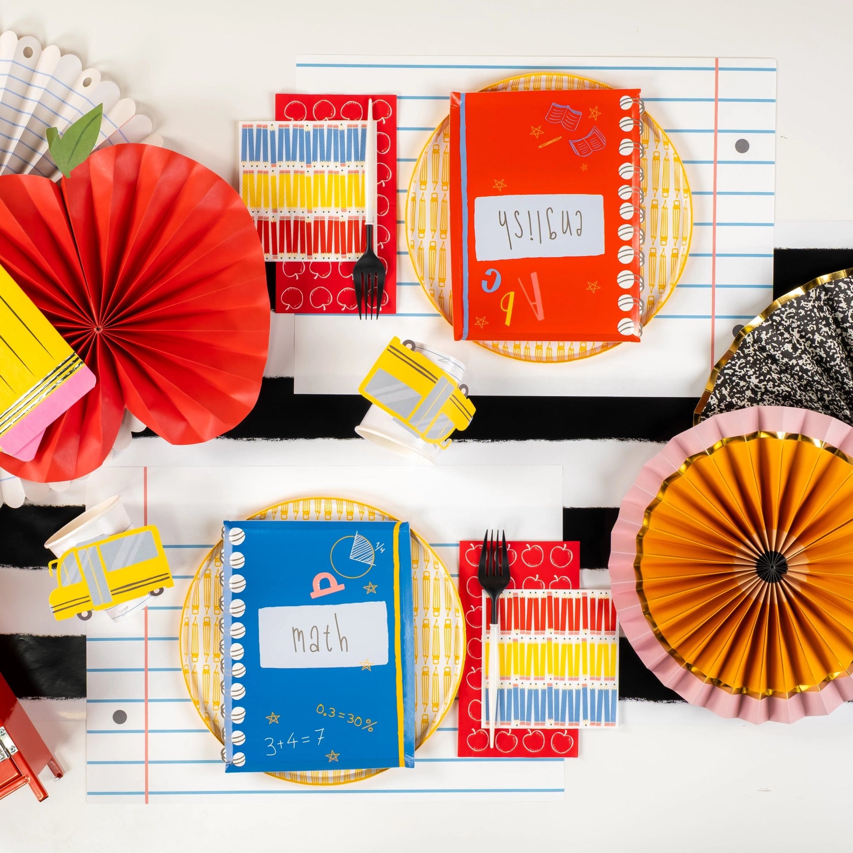 Overhead shot of full school-themed tablescape featuring pencil napkins and notebook plates.