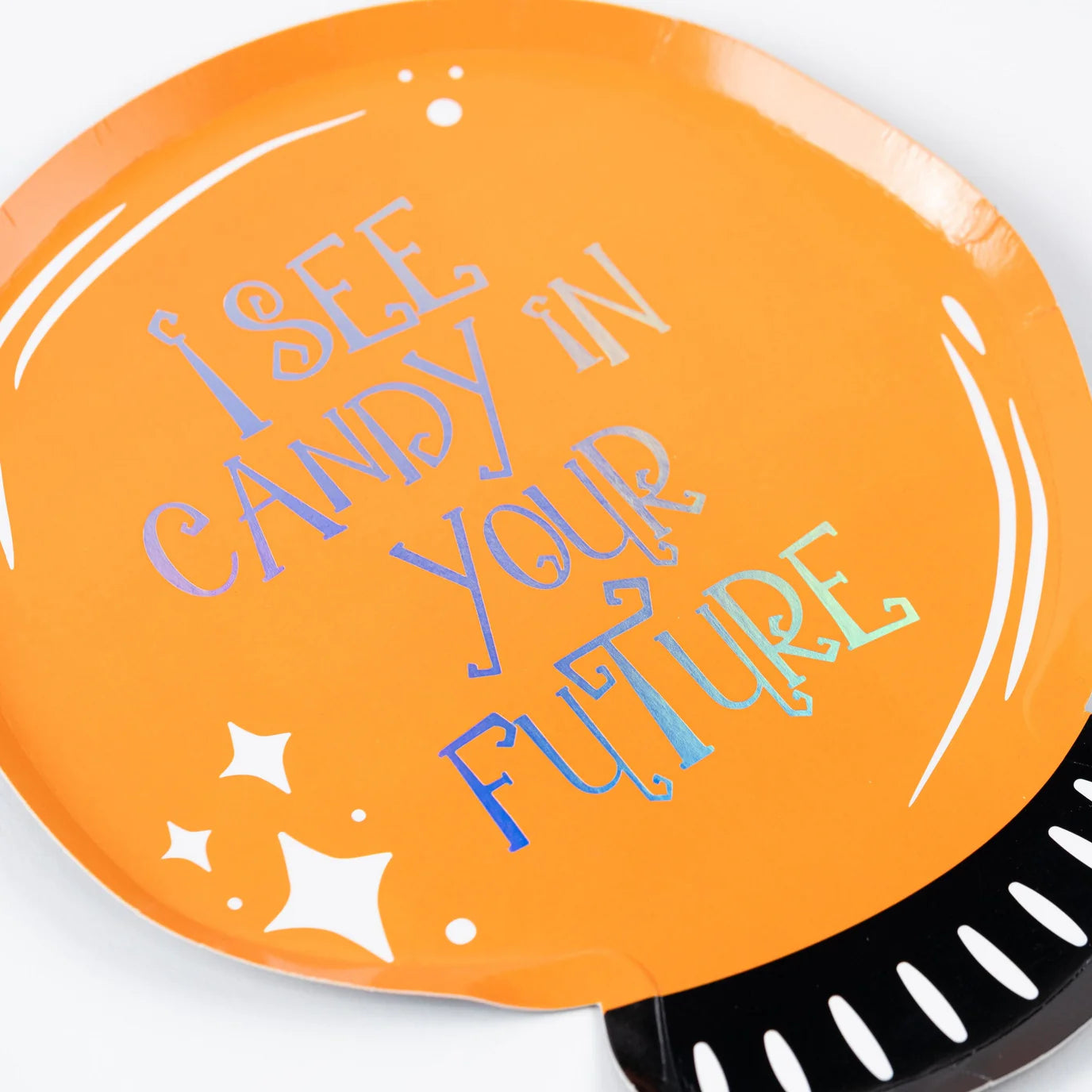 Close up of orange crystal ball plate with holographic text reading I See Candy In Your Future and white sparkles.