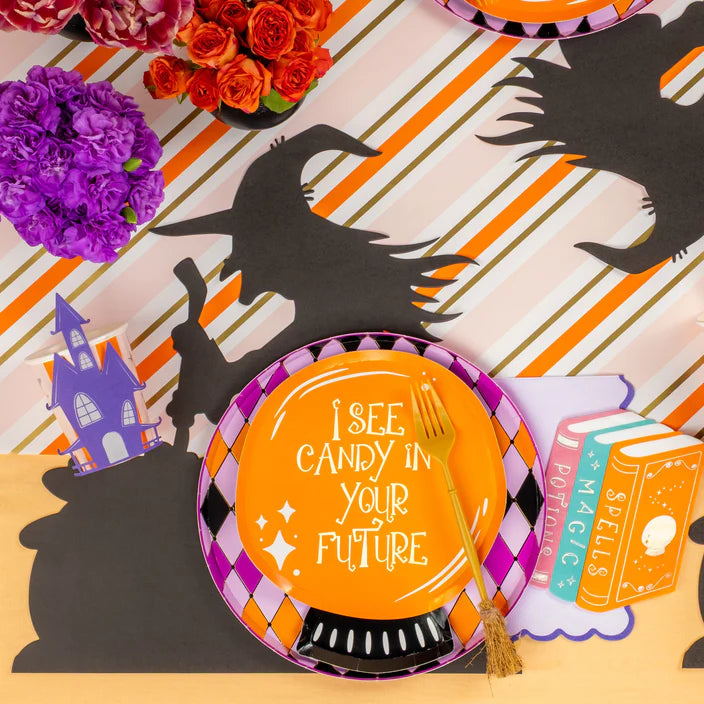 Place setting featuring orange quote plate on harlequin diamond border plate with spellbook decor and witch silhouette placemat.