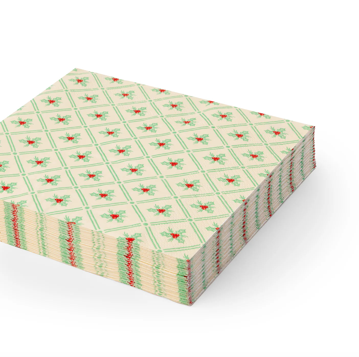 Stack of holly-patterned lunch Christmas paper napkins with green lattice and red berries