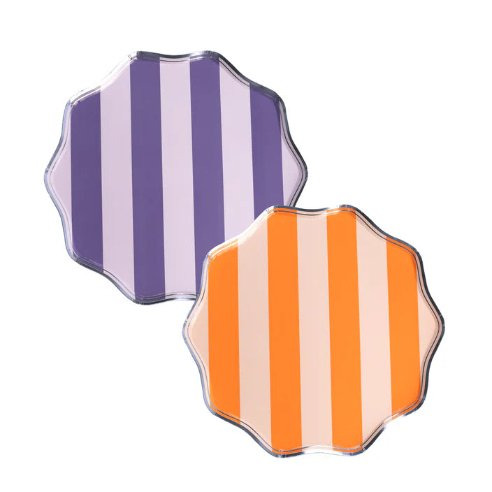 Product image of two striped scalloped dessert plates in purple and orange on white background.