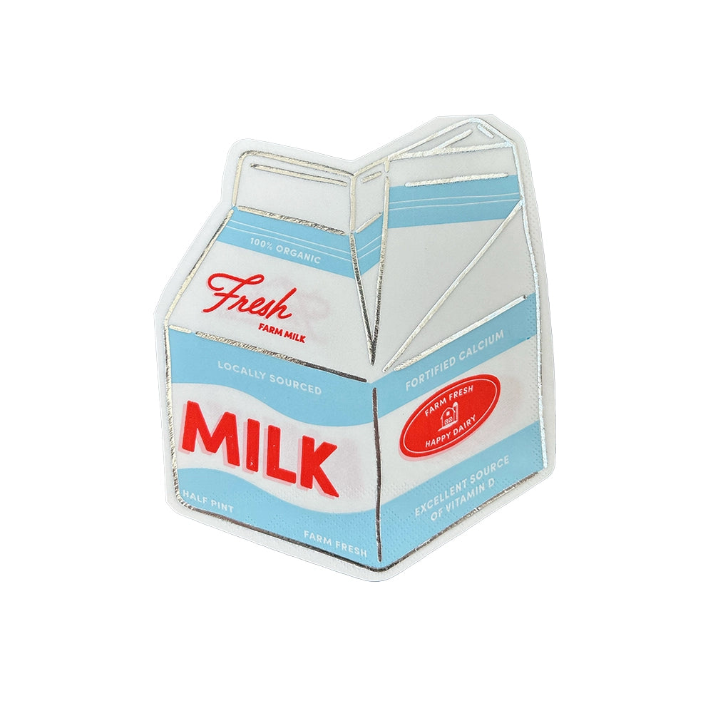 Single die-cut milk-carton napkin on white background showing retro blue label, red “MILK” text, and silver foil accents