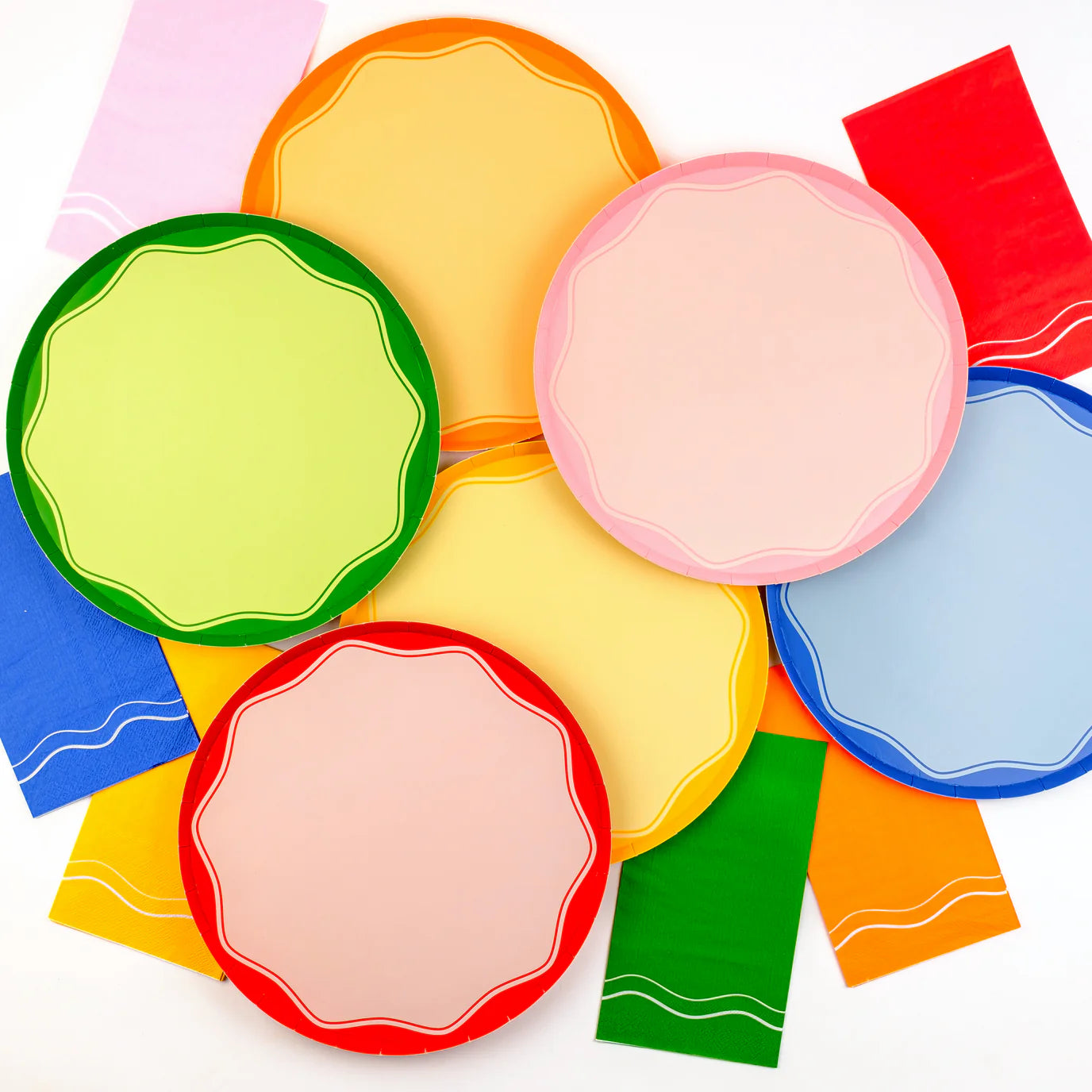Mixed tablescape with assorted color block plates and matching napkins