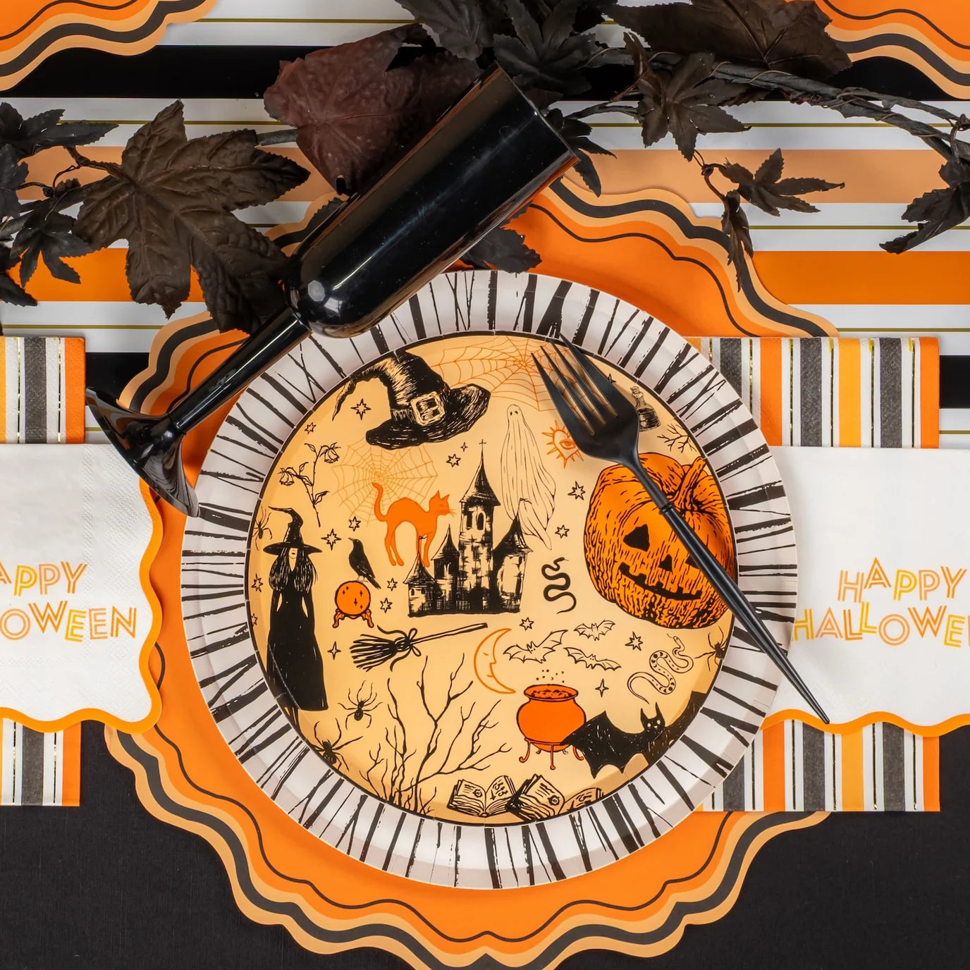 Close up plate setting with stripe guest towel and Happy Halloween napkin