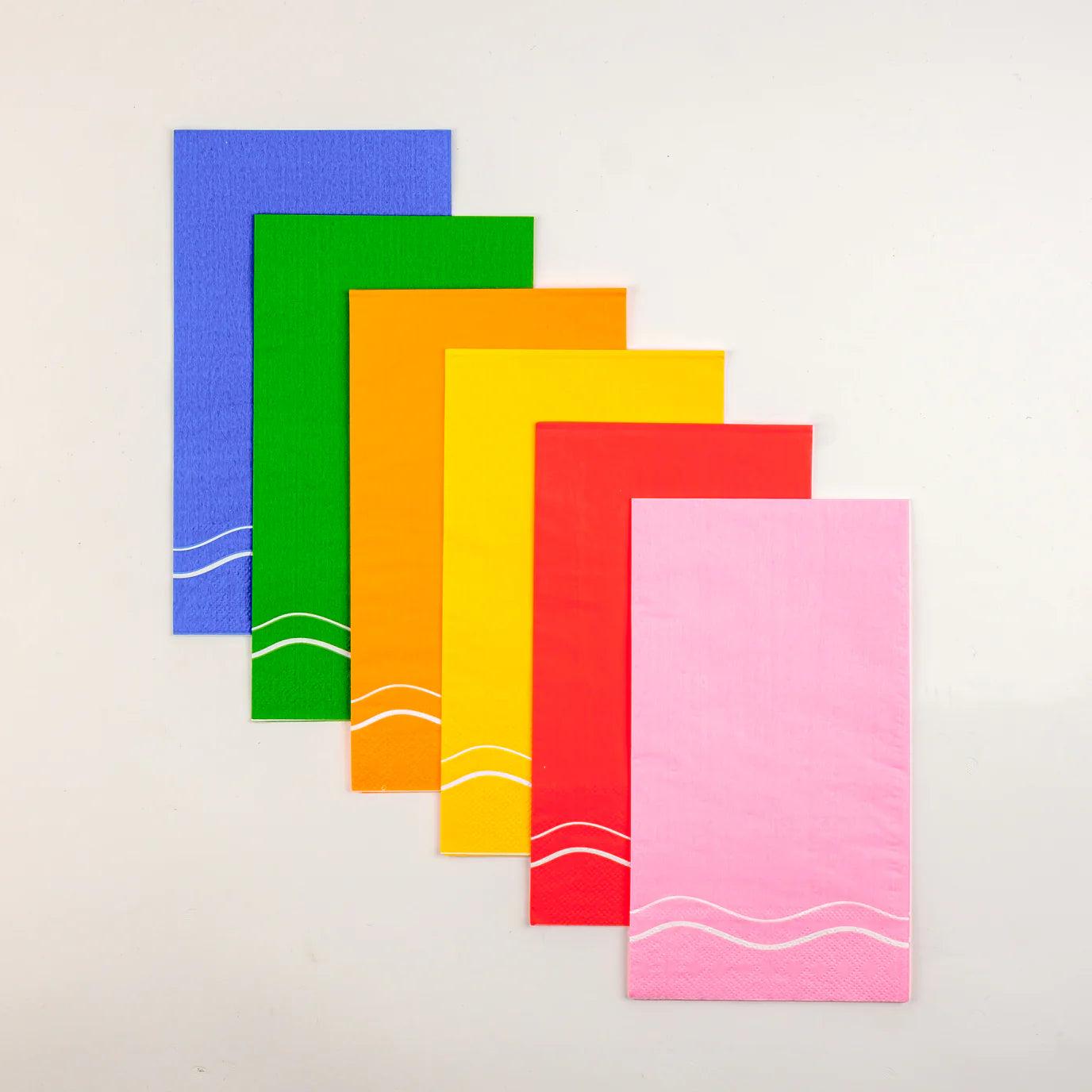 Vertical lineup of six color block guest towels, pink in front