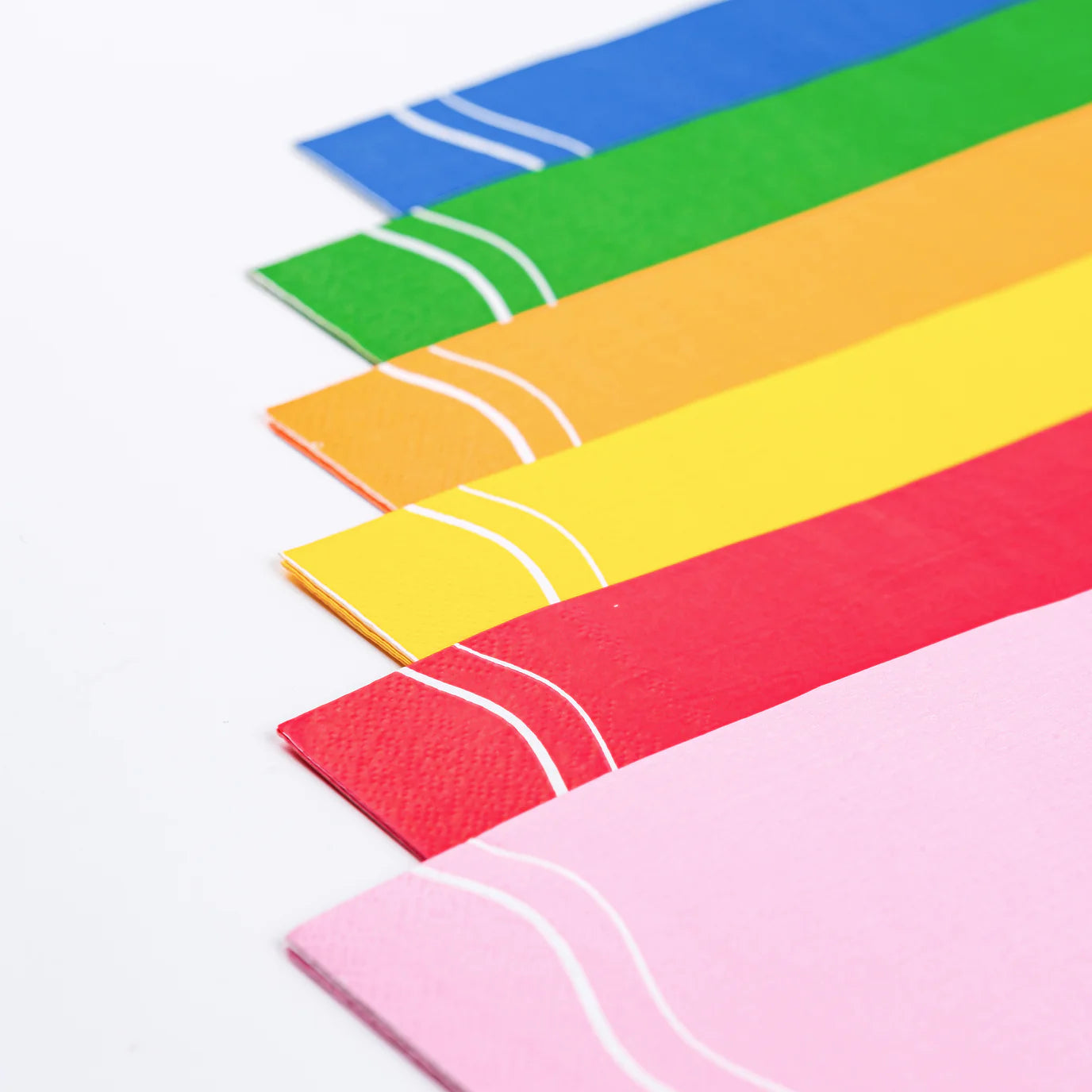Angle view of rainbow guest towels showing pink, red, yellow, orange, green, blue
