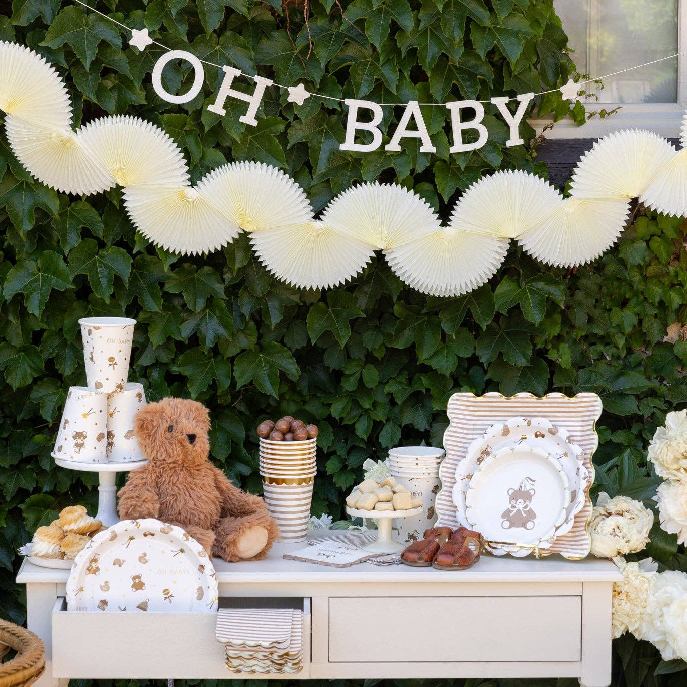 Neutral baby shower table setup with teddy bear party plates