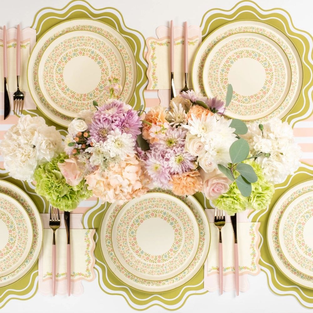 pastel floral plates arranged on table with spring decor.