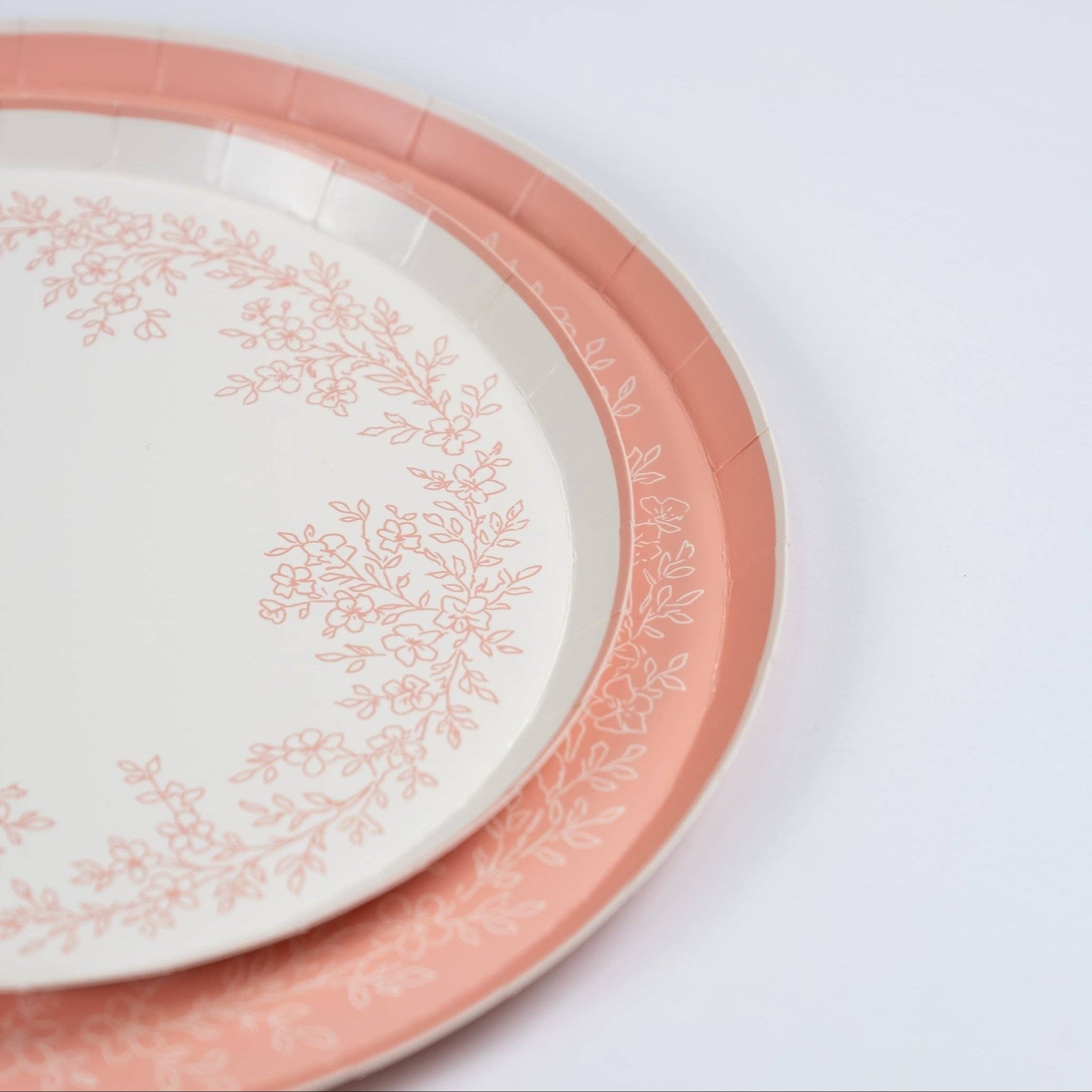 Pink plate stacked with coordinating floral dinner plate closeup