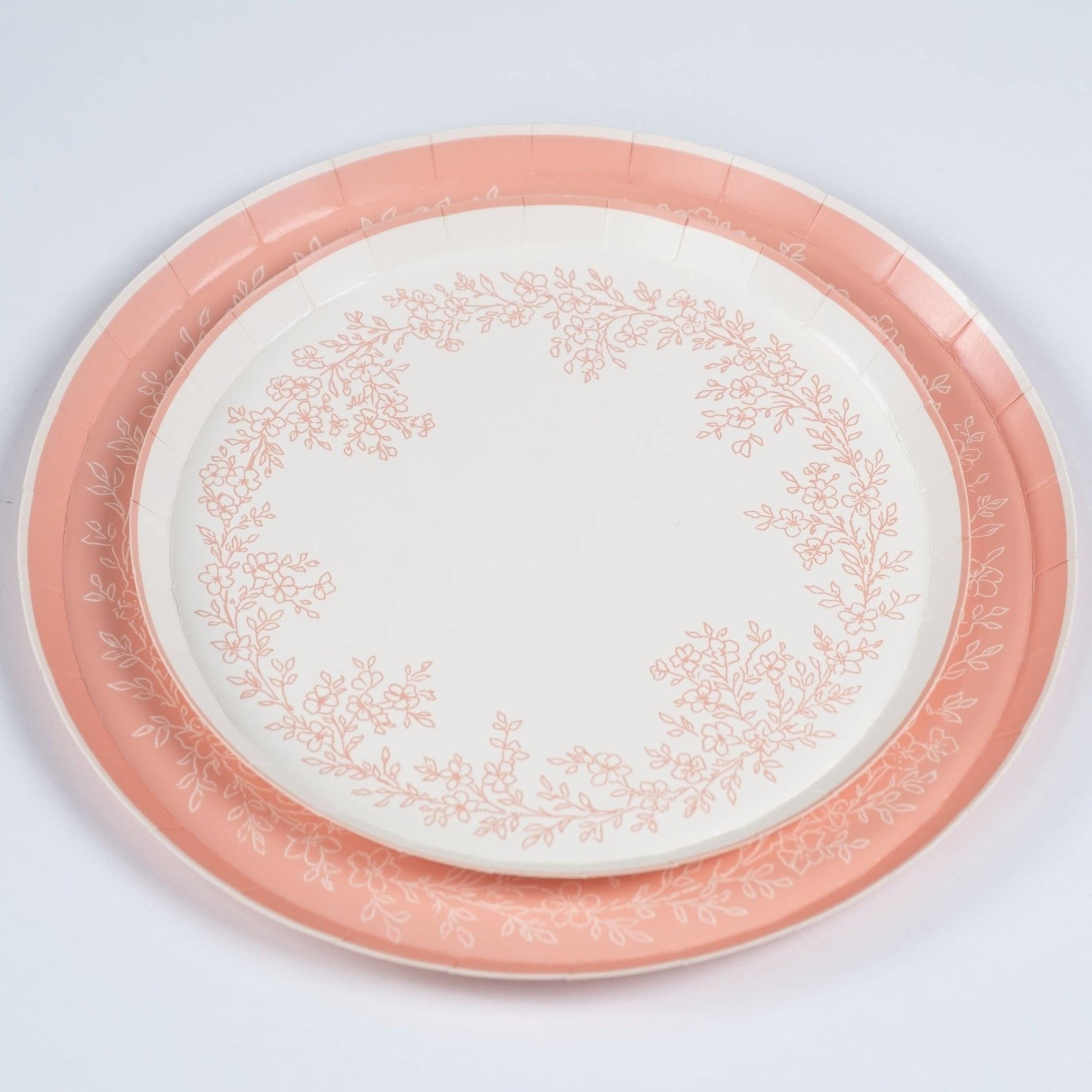 Pink plate stacked with coordinating floral dinner plate