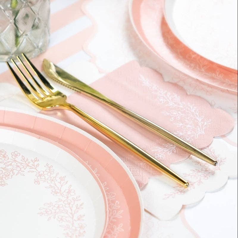 Closeup of Pink guest towel paired with a pink lace plate and gold fork