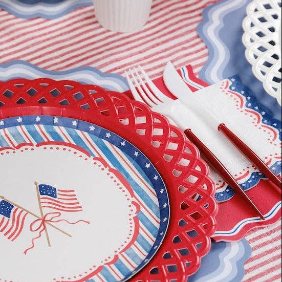 Close-up of Patriotic Guest Towels styled with red-handled utensils for a BBQ buffet.