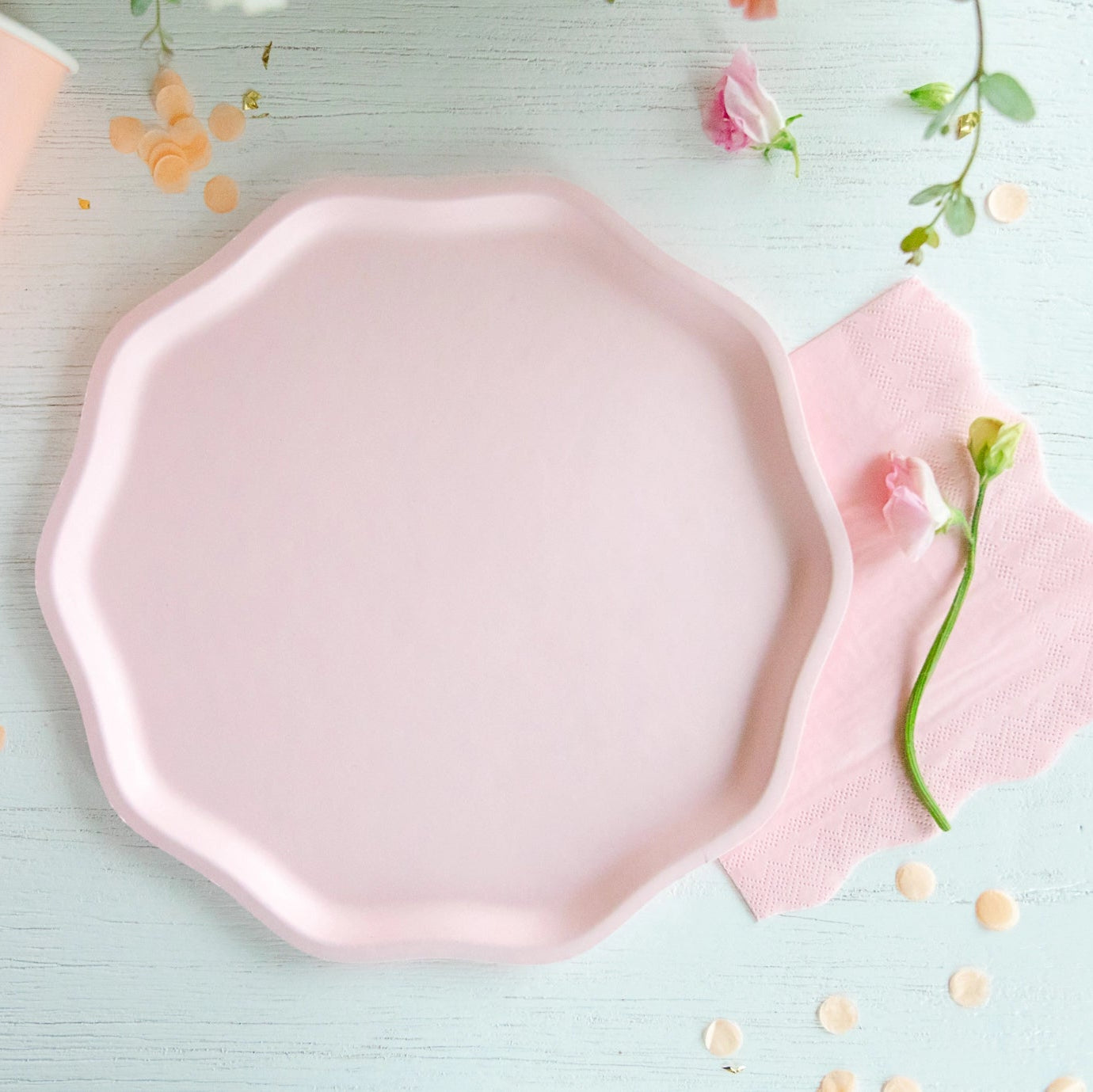 Single petal pink compostable dinner plate on table with matching cup and napkin—ideal girl baby shower plates.