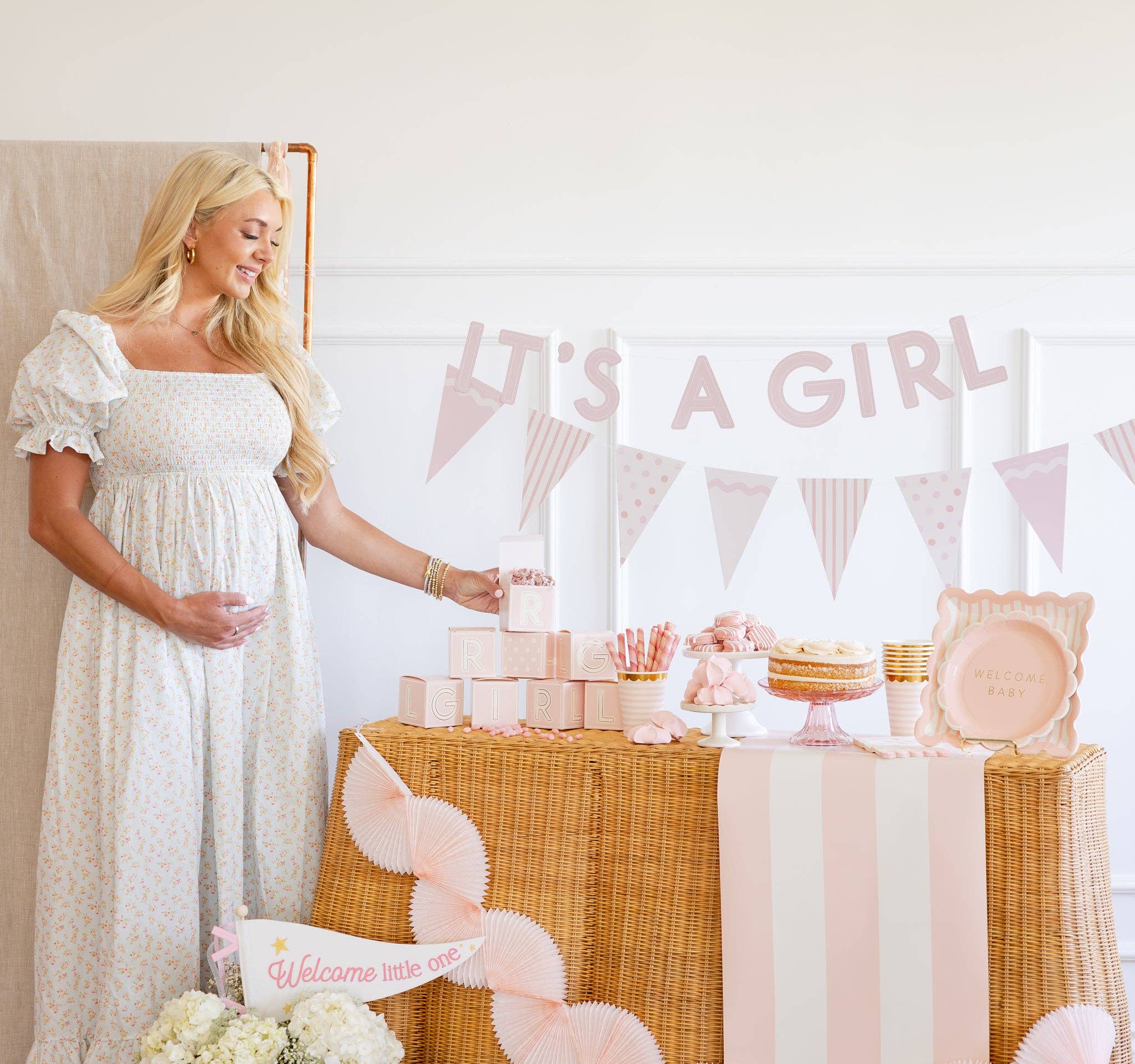Pink block treat boxes displayed on baby girl shower dessert table
