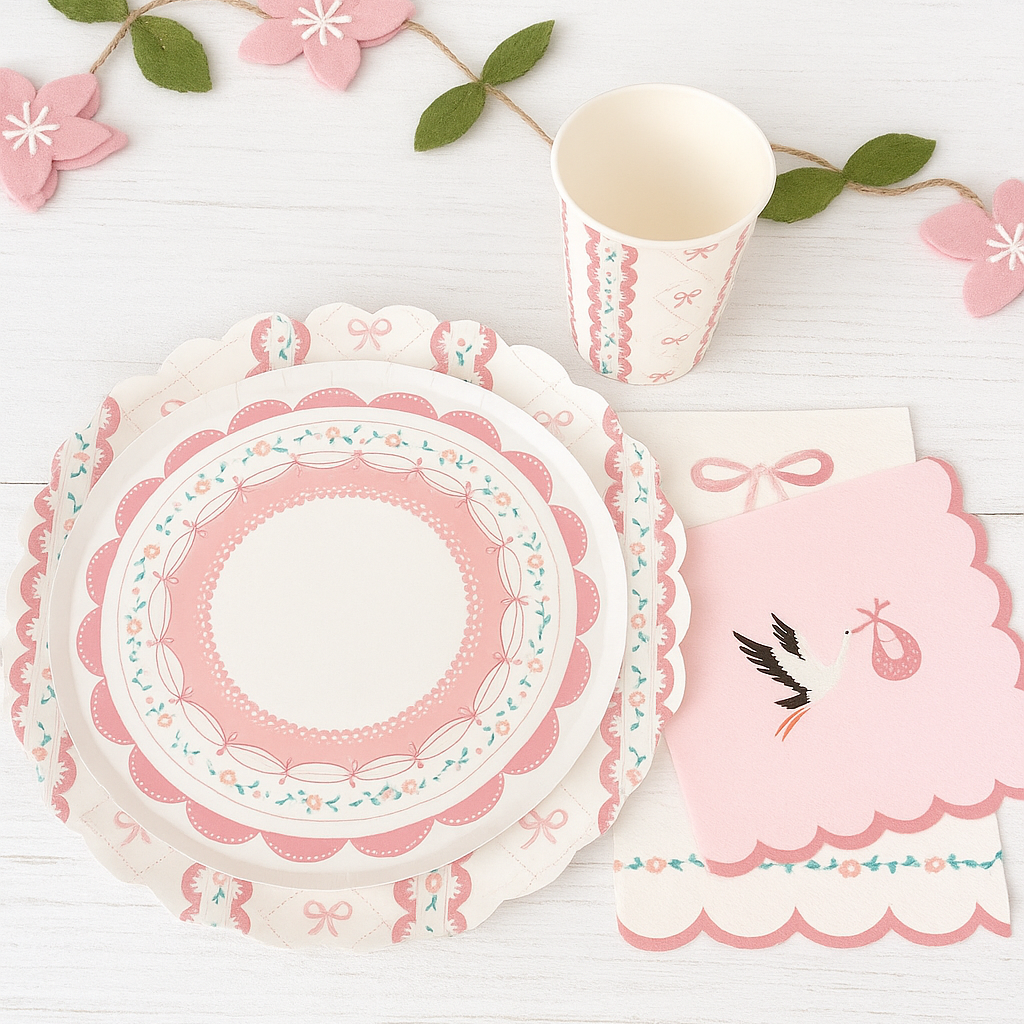 Pink bow cup with a baby shower place setting and stork napkin