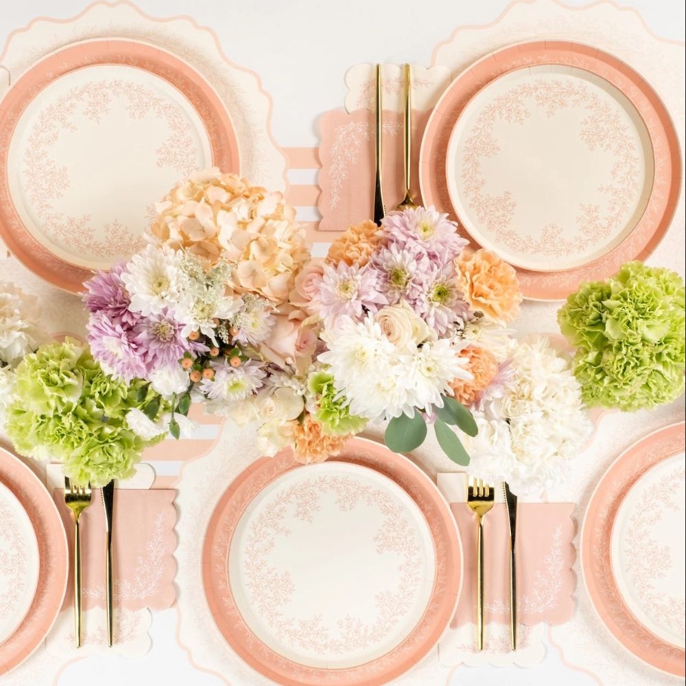 Top view of pink floral plates with pastel decor