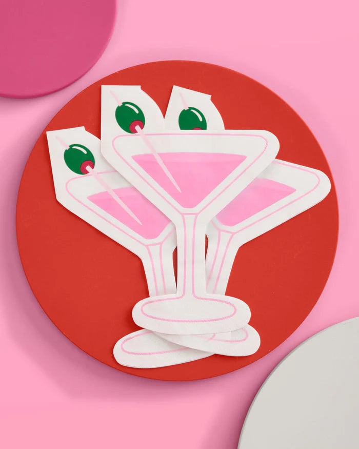 Stack of three pink martini shaped cocktail napkins fanned on a red plate
