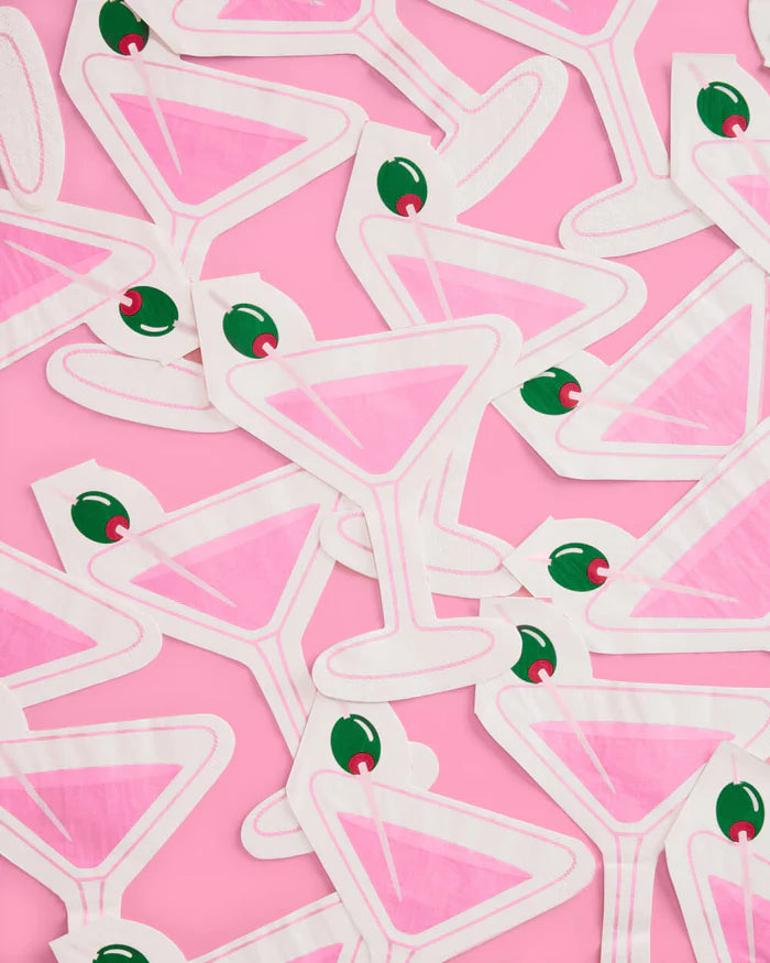 Pile of pink martini glass-shaped paper cocktail napkins with green olive detail on pink background